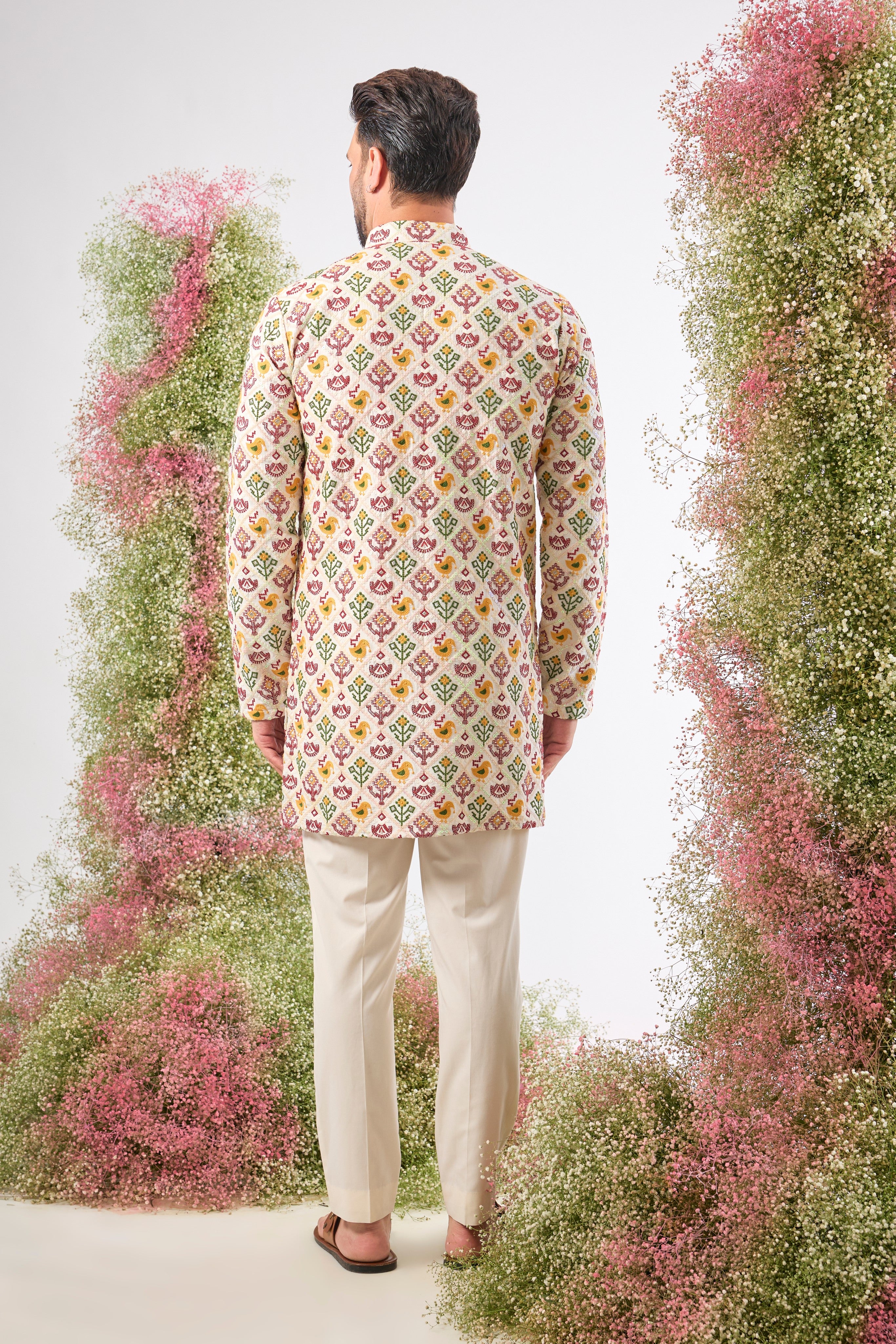 his White Short Kurta showcases the stunning geometric patterns of Phulkari Embroidery using a rich array of Multi-coloured Threads. The subtle sequin detailing adds a perfect touch of festive shimmer.