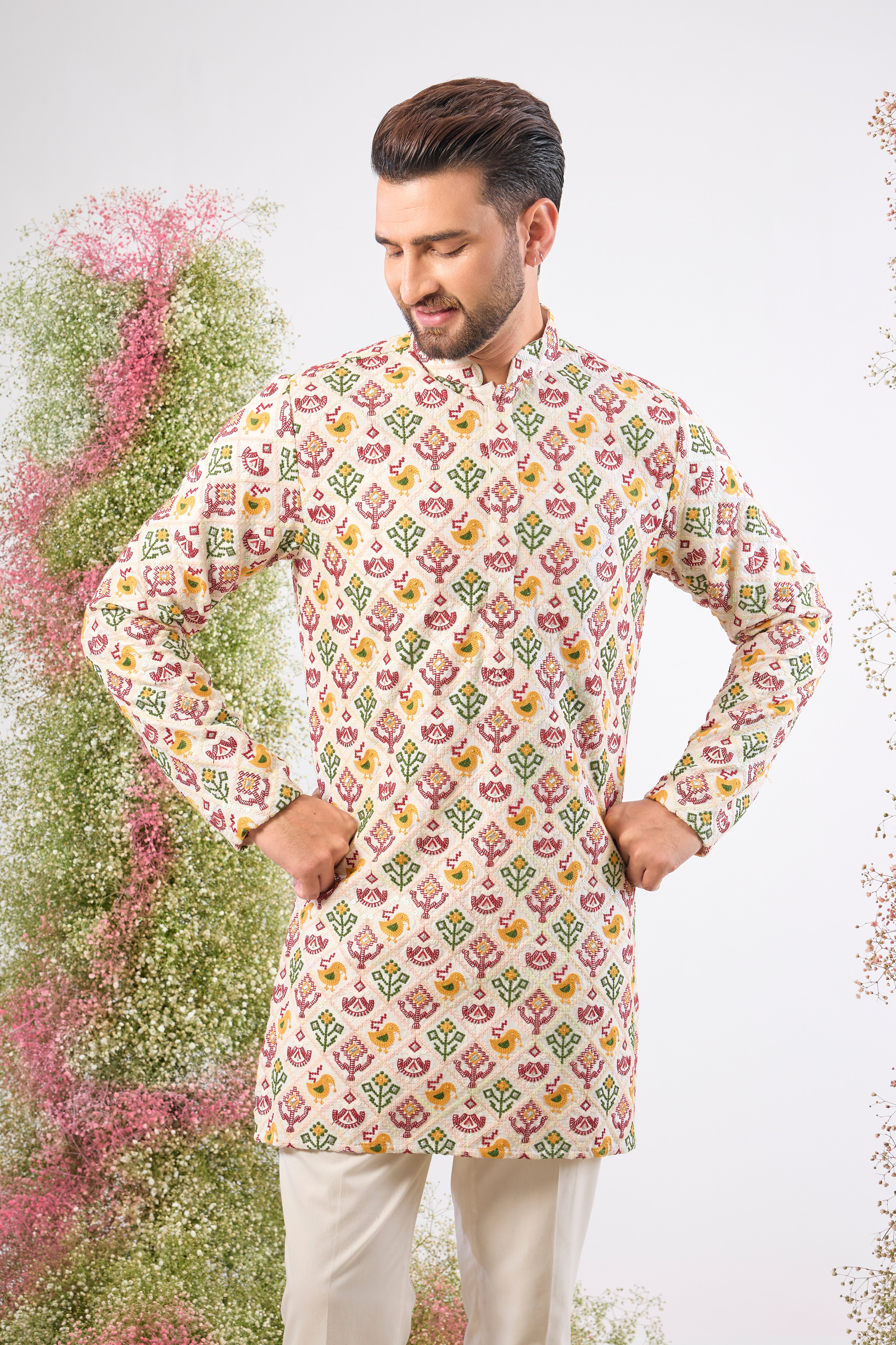 his White Short Kurta showcases the stunning geometric patterns of Phulkari Embroidery using a rich array of Multi-coloured Threads. The subtle sequin detailing adds a perfect touch of festive shimmer.