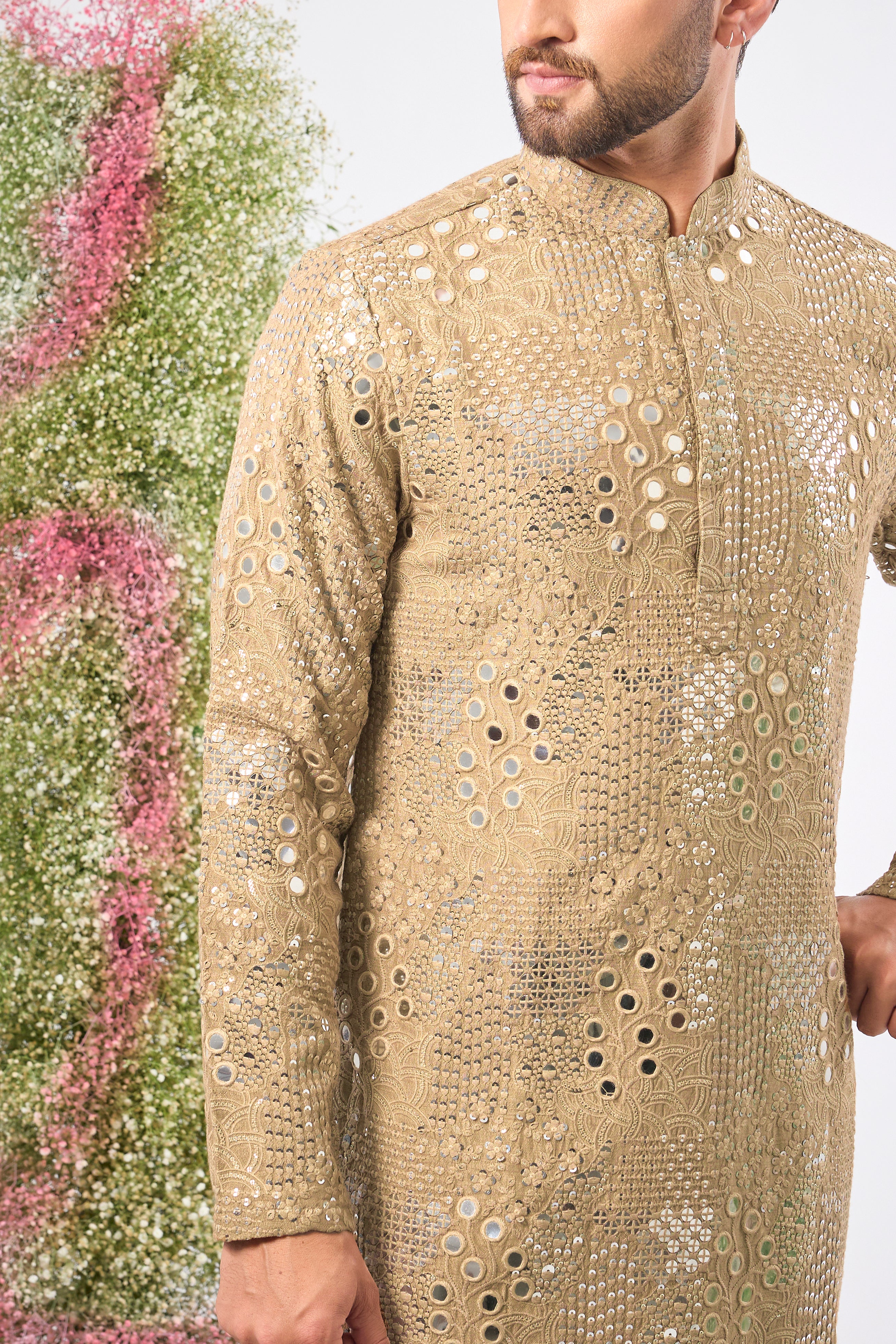 This Copper- brown Mirror Work Kurta showcases exquisite Intricate Floral Patterns, beautifully highlighted by the reflective Sequin Work. The combination creates depth and a continuous, captivating shimmer.