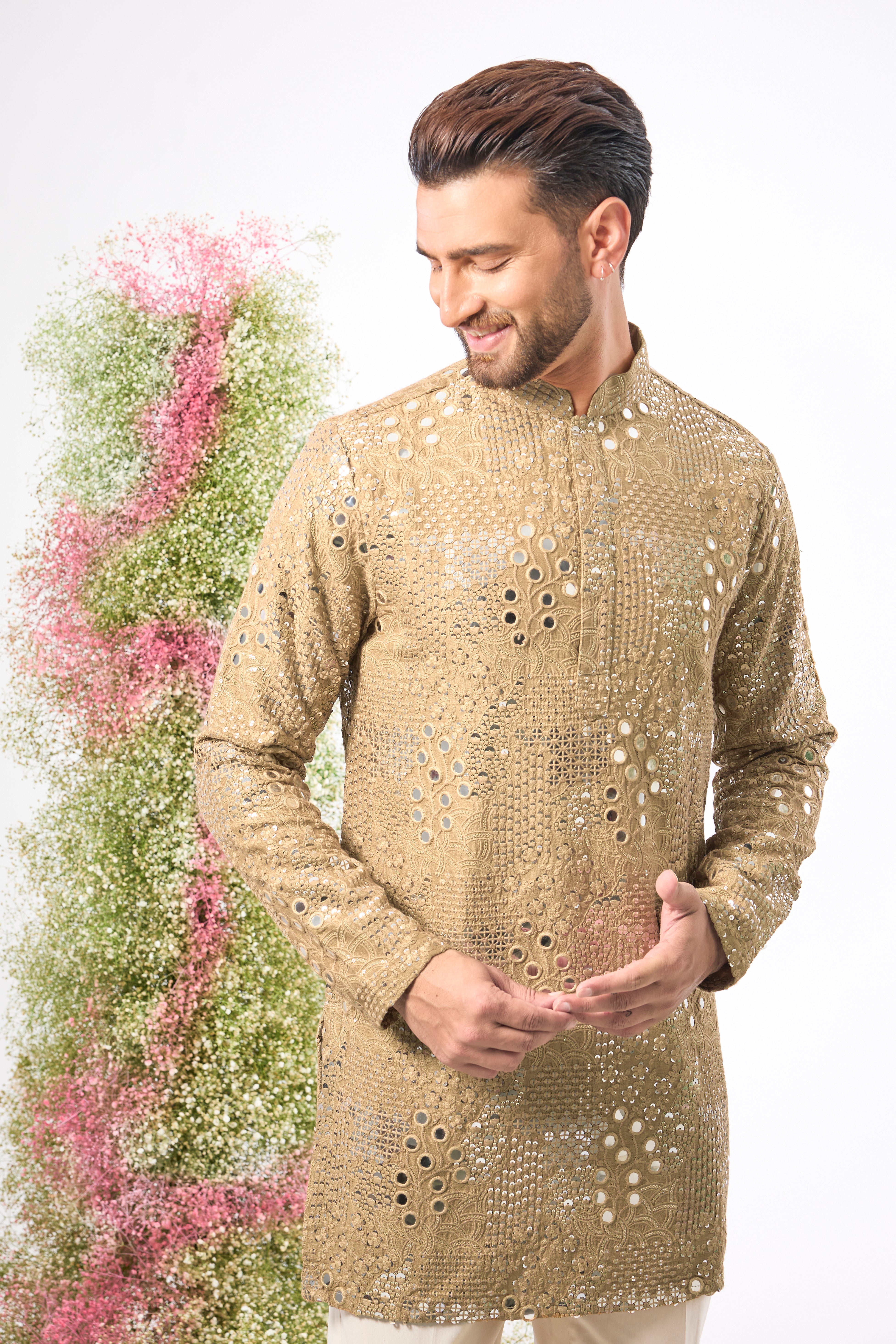 This Copper- brown Mirror Work Kurta showcases exquisite Intricate Floral Patterns, beautifully highlighted by the reflective Sequin Work. The combination creates depth and a continuous, captivating shimmer.