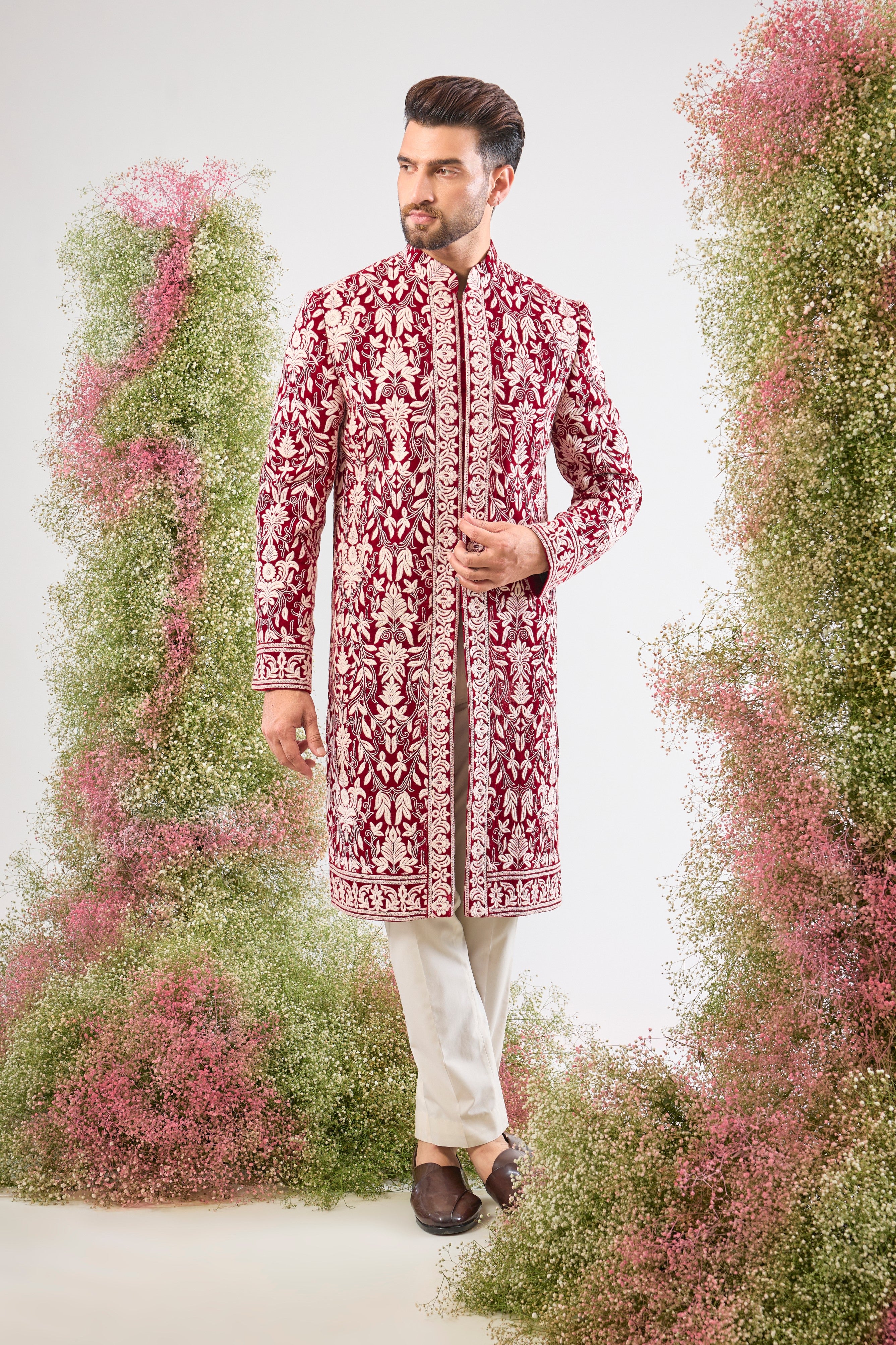 Our Maroon Sherwani on Velvet is a masterpiece, showcasing rich velvet fabric adorned with exquisite White Threadwork in a classic Kashmiri Embroidery Pattern