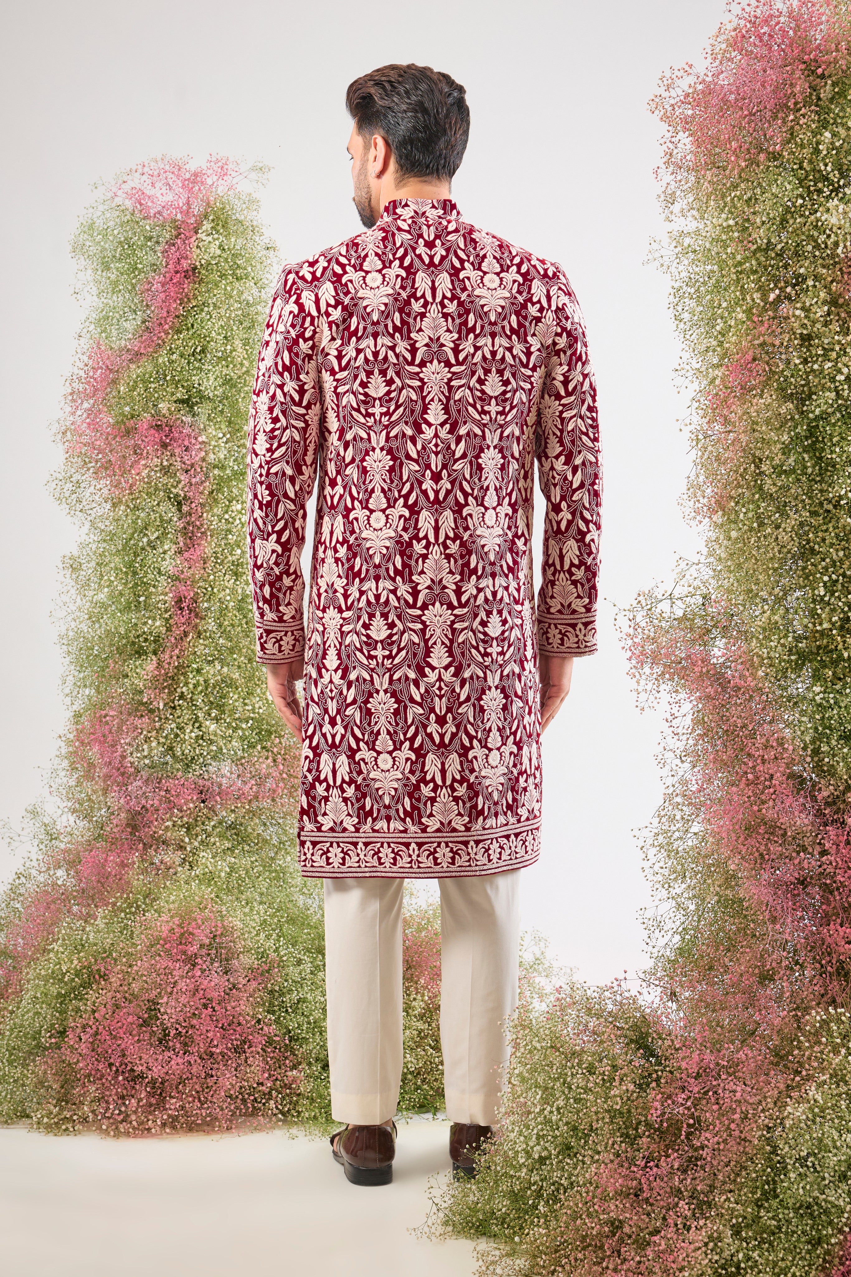 Our Maroon Sherwani on Velvet is a masterpiece, showcasing rich velvet fabric adorned with exquisite White Threadwork in a classic Kashmiri Embroidery Pattern