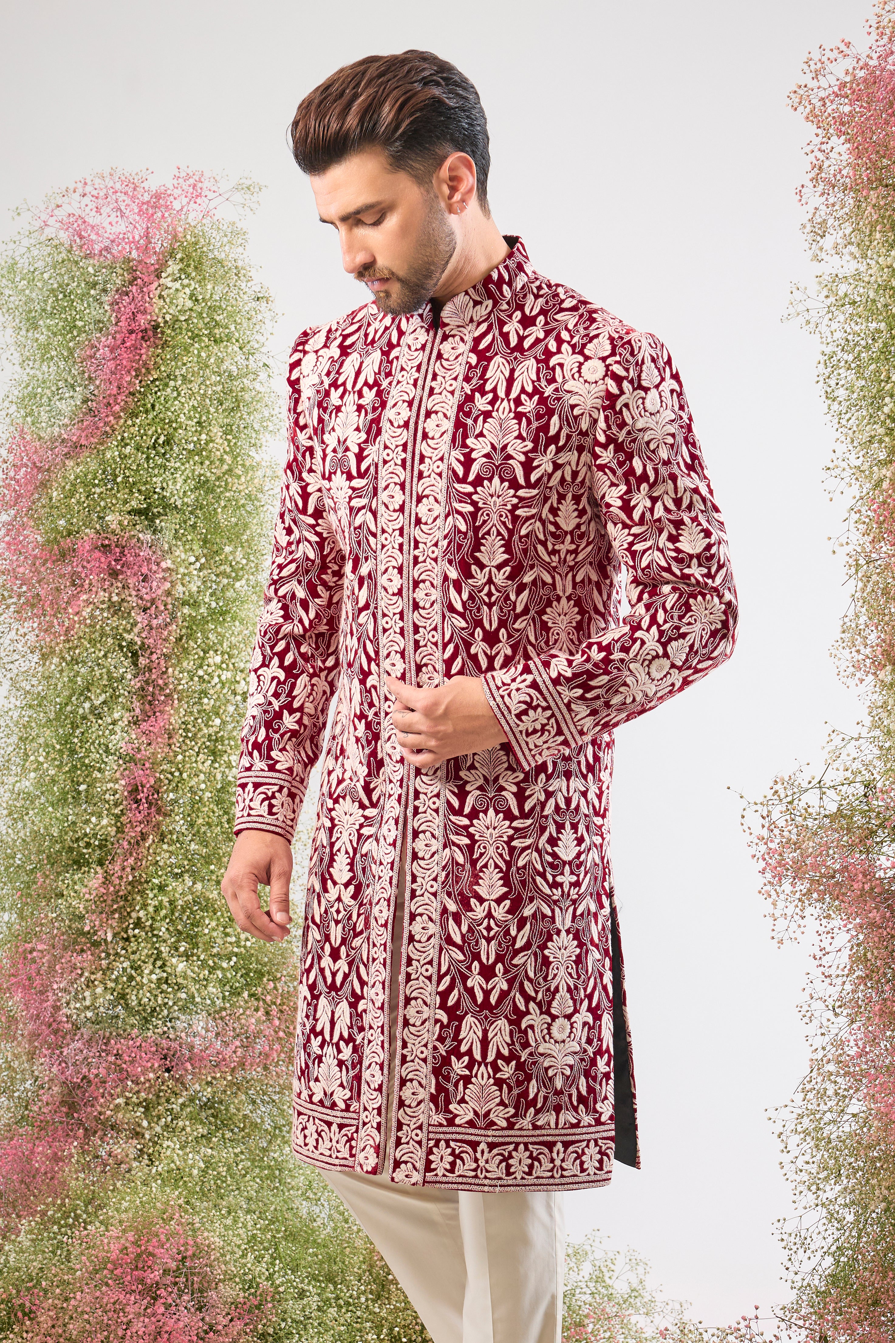 Our Maroon Sherwani on Velvet is a masterpiece, showcasing rich velvet fabric adorned with exquisite White Threadwork in a classic Kashmiri Embroidery Pattern