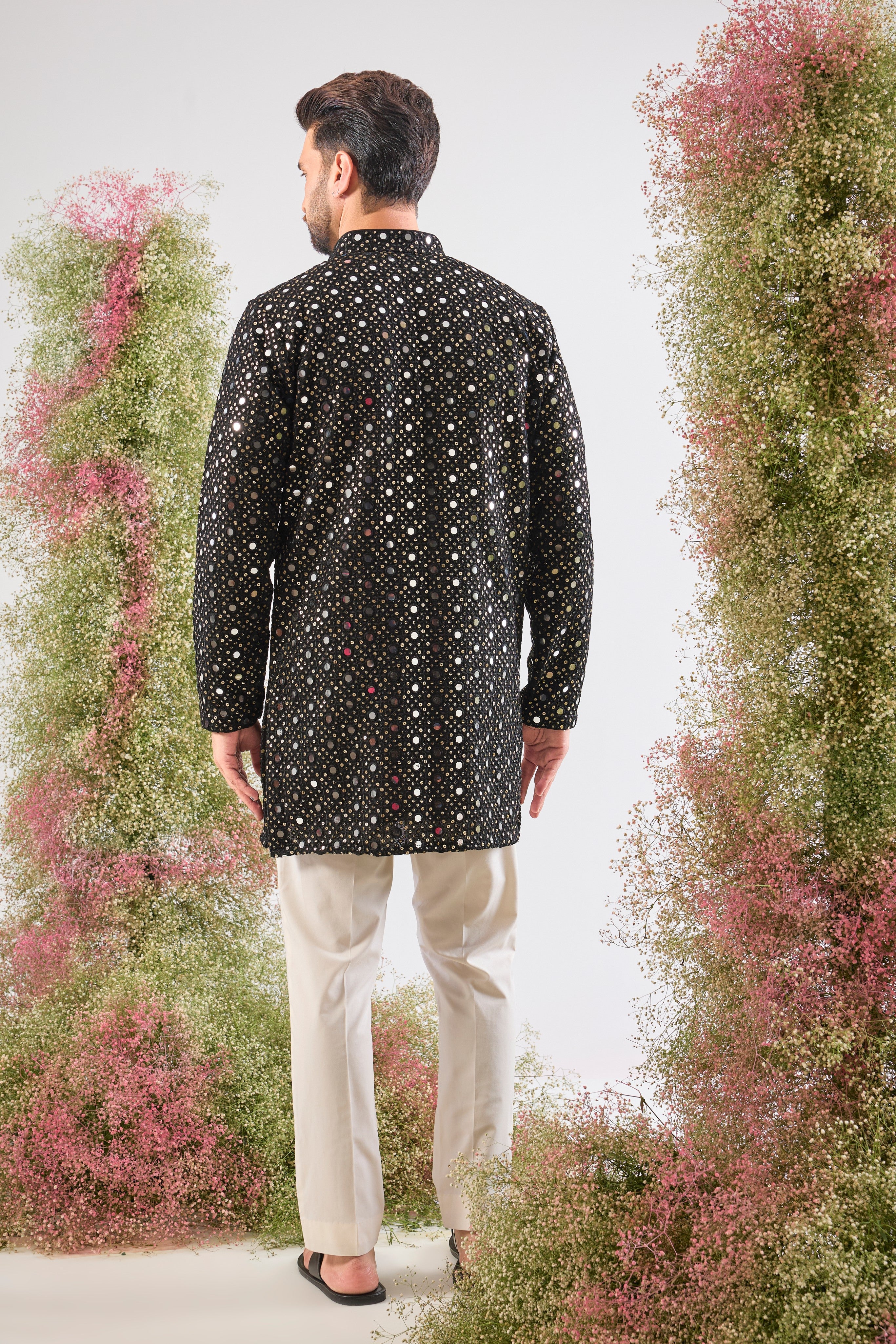 This Short Mirror Work Kurta showcases the richness of a dark base illuminated by continuous, Heavy Sequin Work. The dense sequin coverage ensures a luminous, unforgettable texture, making it the definition of sophisticated party wear.