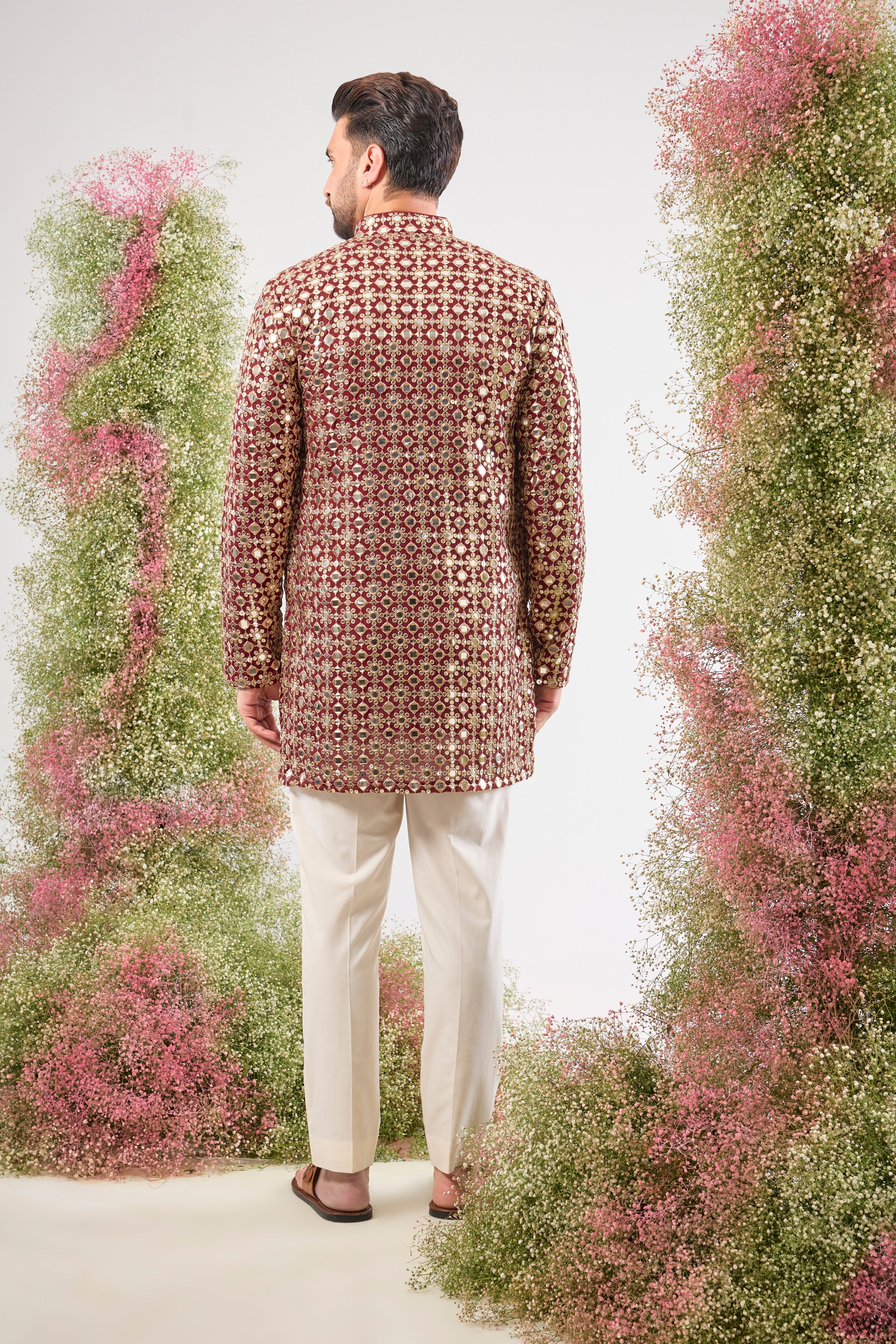 This Maroon Mirror Work Short Kurta showcases the dramatic texture of Heavy Zari Work, seamlessly blended with the brilliant shimmer of Detailed Sequins. The result is a garment that offers unmatched depth and sparkle, capturing light beautifully.