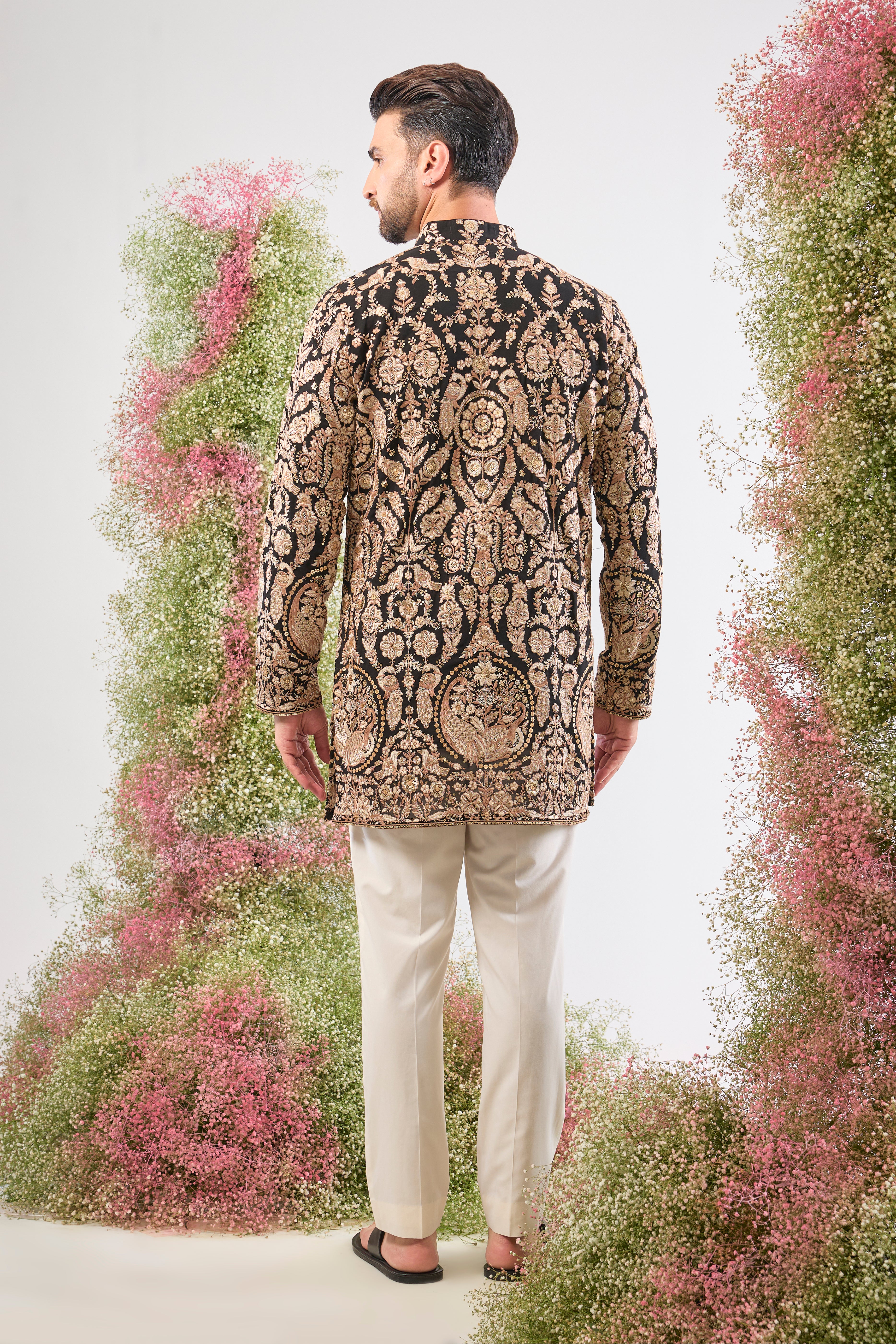 This Black Short Kurta showcases the weight of Heavy Zari Work, expertly framing Intricate Flora and Fauna Embroidery.