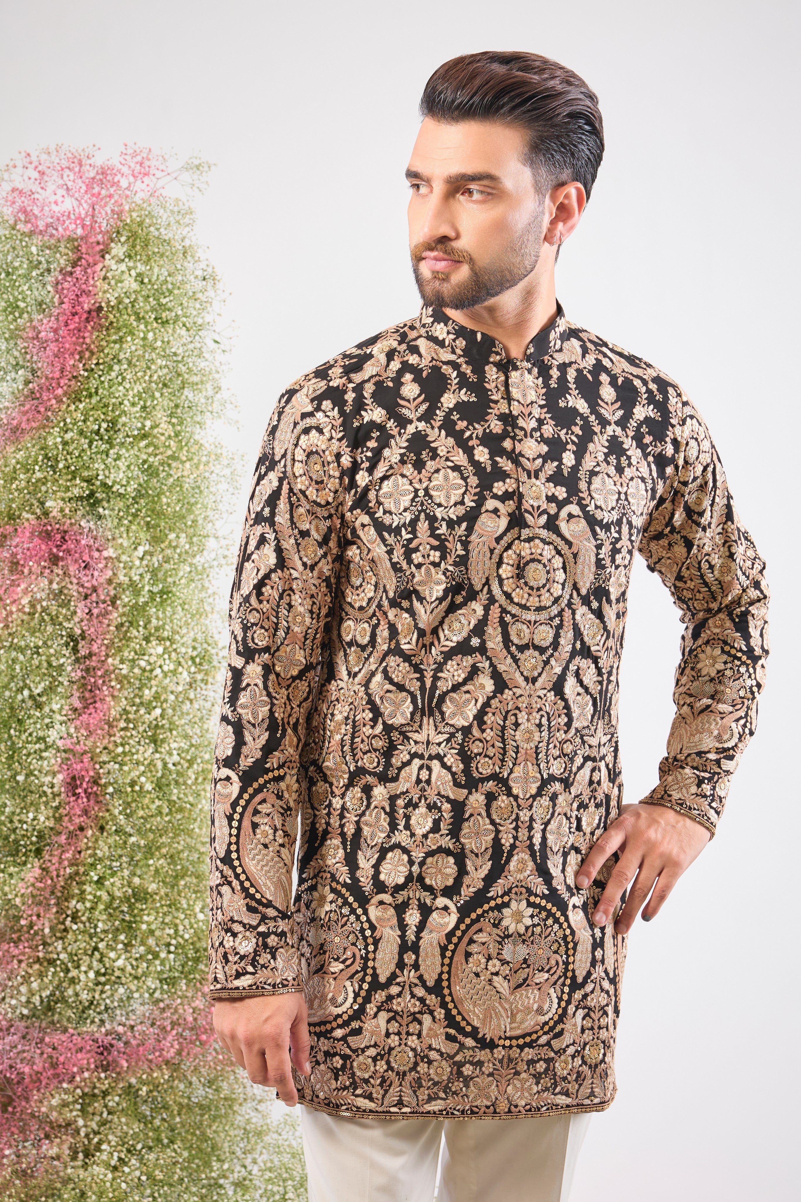 This Black Short Kurta showcases the weight of Heavy Zari Work, expertly framing Intricate Flora and Fauna Embroidery.