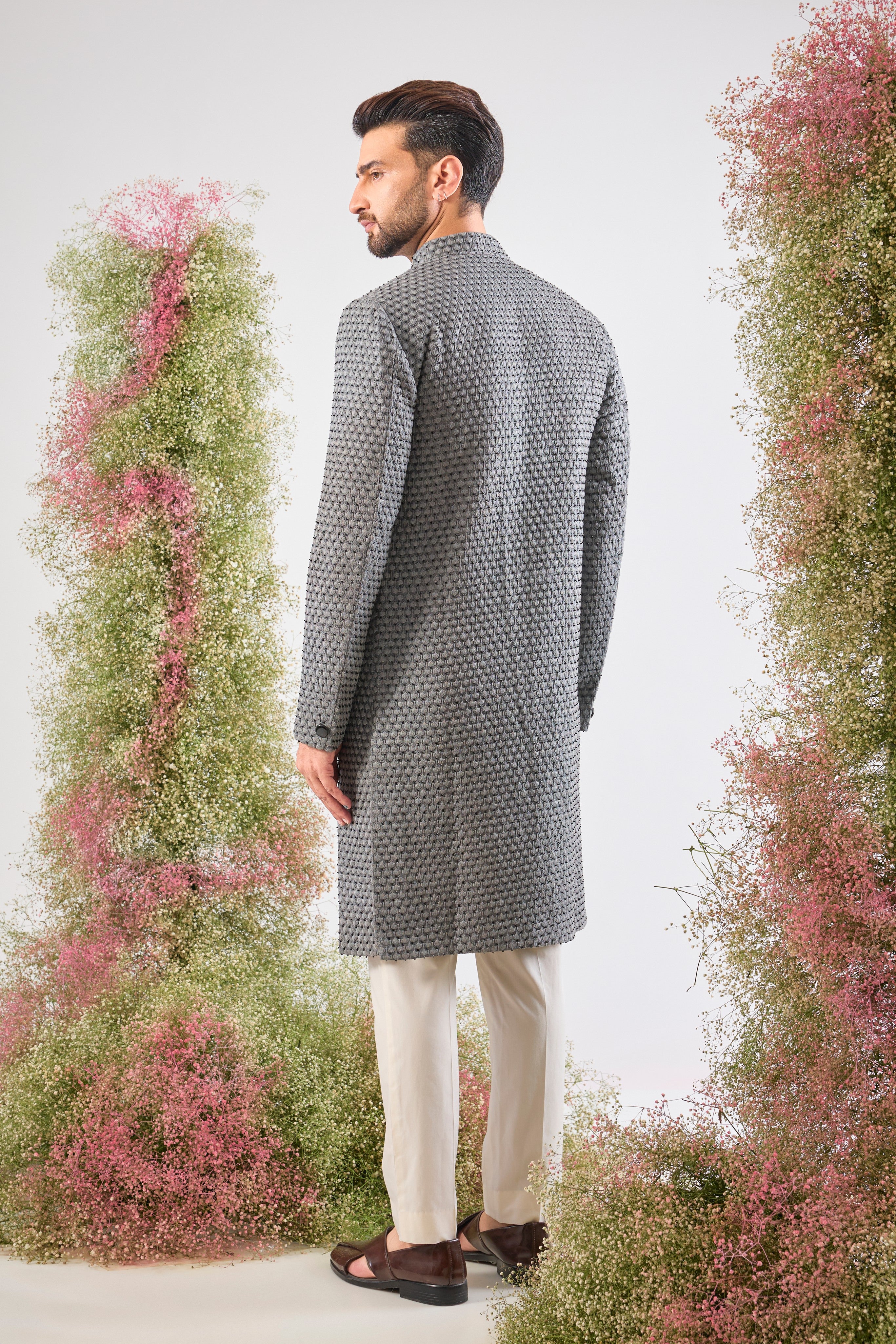 This Sherwani is a masterpiece of design, showcasing the density of Heavy Thread Work layered with the brilliant reflection of Black Cut Dana.