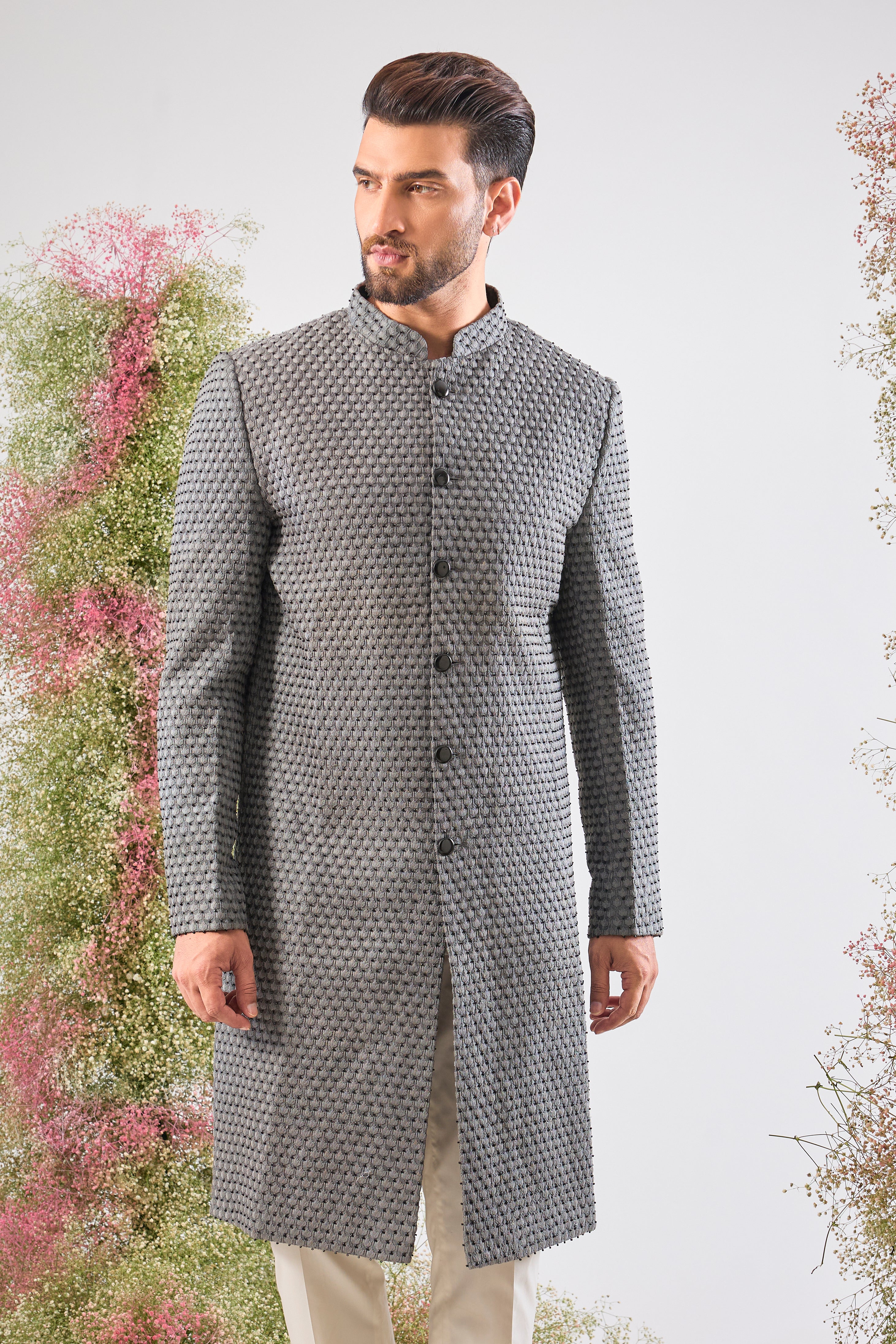 This Sherwani is a masterpiece of design, showcasing the density of Heavy Thread Work layered with the brilliant reflection of Black Cut Dana.