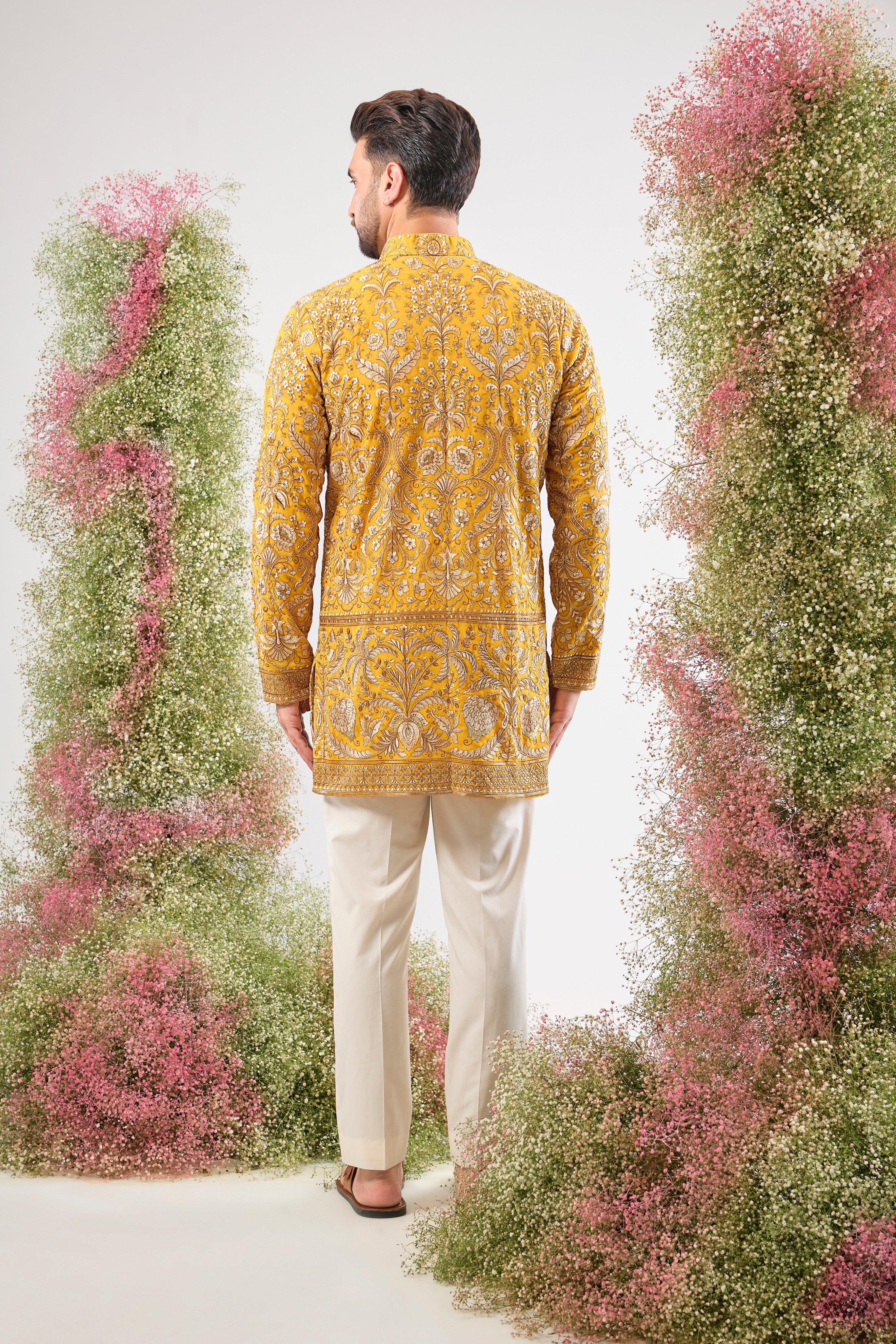 This Yellow Short Kurta is a masterpiece of texture, showcasing Heavy Zari Work layered with sparkling Sequins and rich Detailed Floral Embroidery. The dense handwork creates an opulent look, perfectly balancing vibrancy and sophistication.