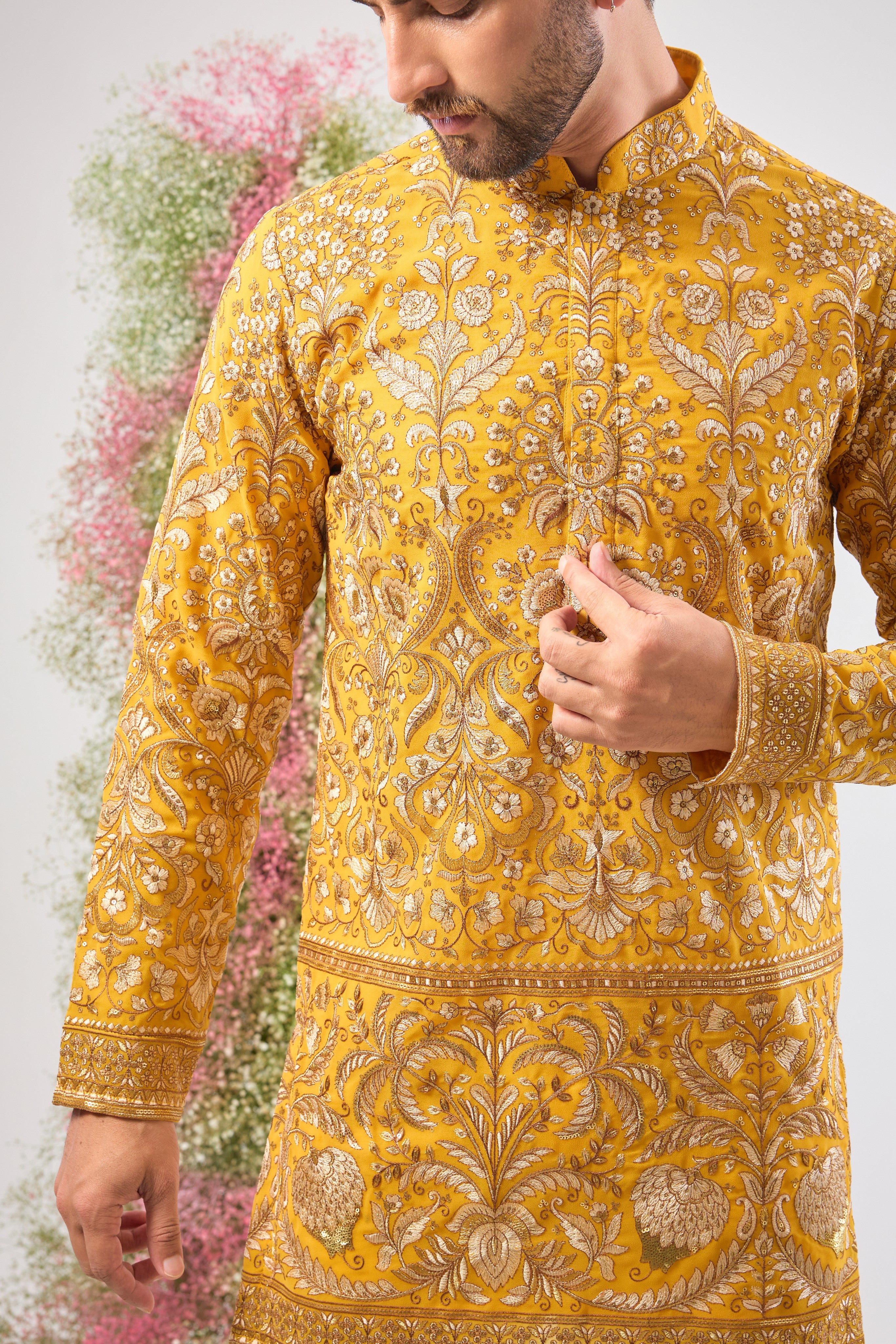 This Yellow Short Kurta is a masterpiece of texture, showcasing Heavy Zari Work layered with sparkling Sequins and rich Detailed Floral Embroidery. The dense handwork creates an opulent look, perfectly balancing vibrancy and sophistication.