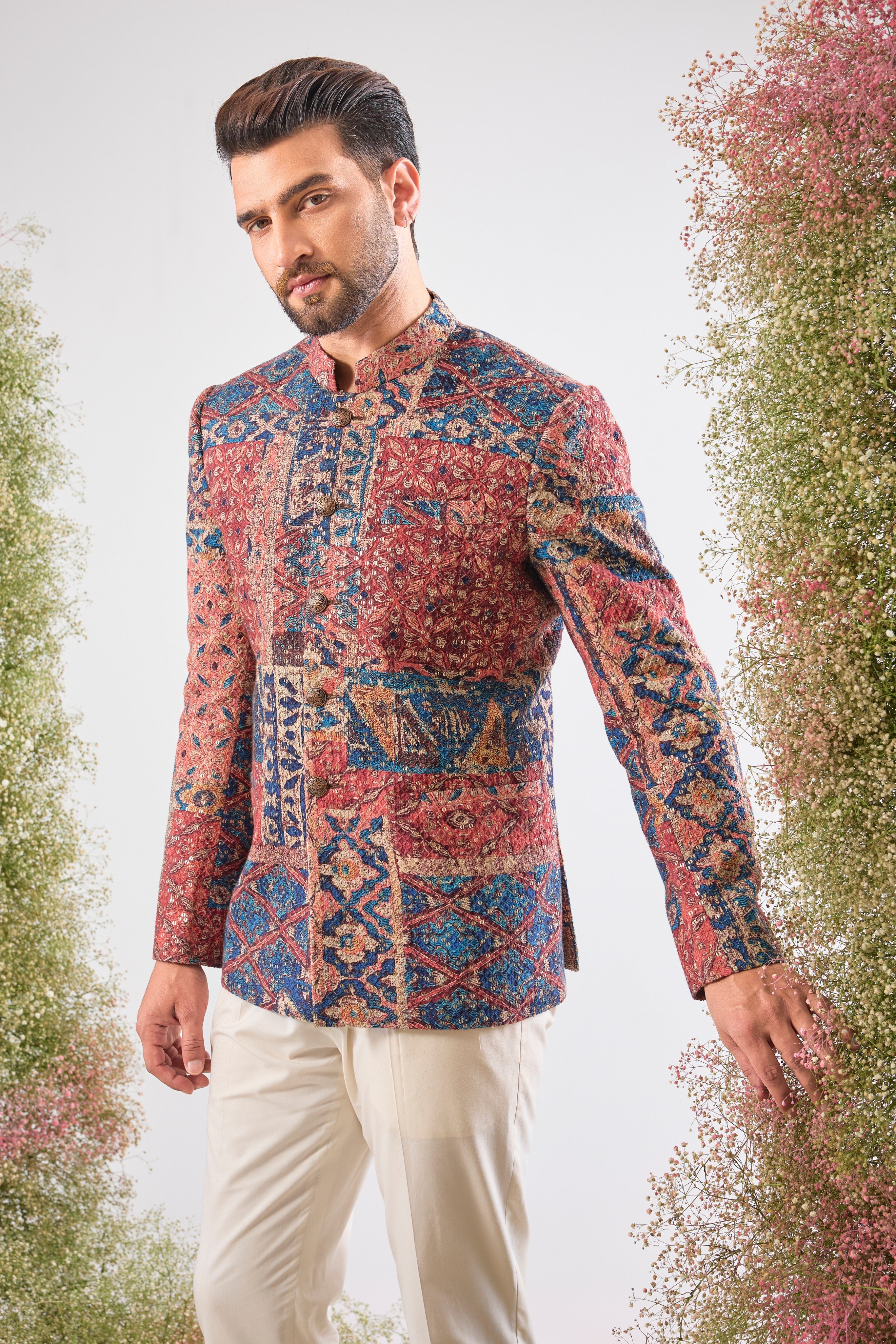 his Multi-coloured Bandhgala showcases a mesmerizing Abstract Royal Geometrical Print that is beautifully layered with fine Thread Work. The inclusion of Sequin Detailing ensures a subtle, festive shimmer, creating a truly dynamic and luxurious garment.