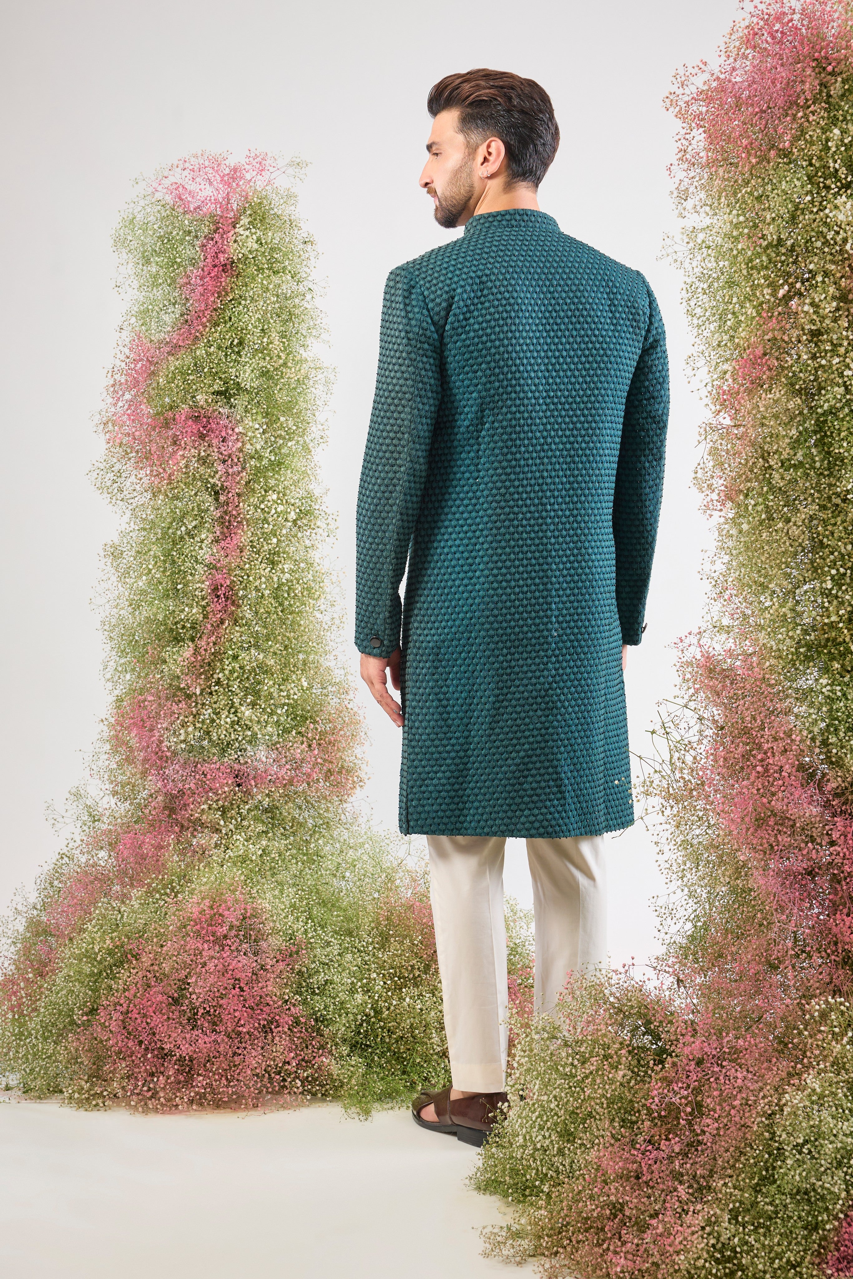 This Sherwani is lavishly detailed with Heavy Thread Work layered with the striking contrast of Black Cut Dana, offering both depth and subtle sparkle.