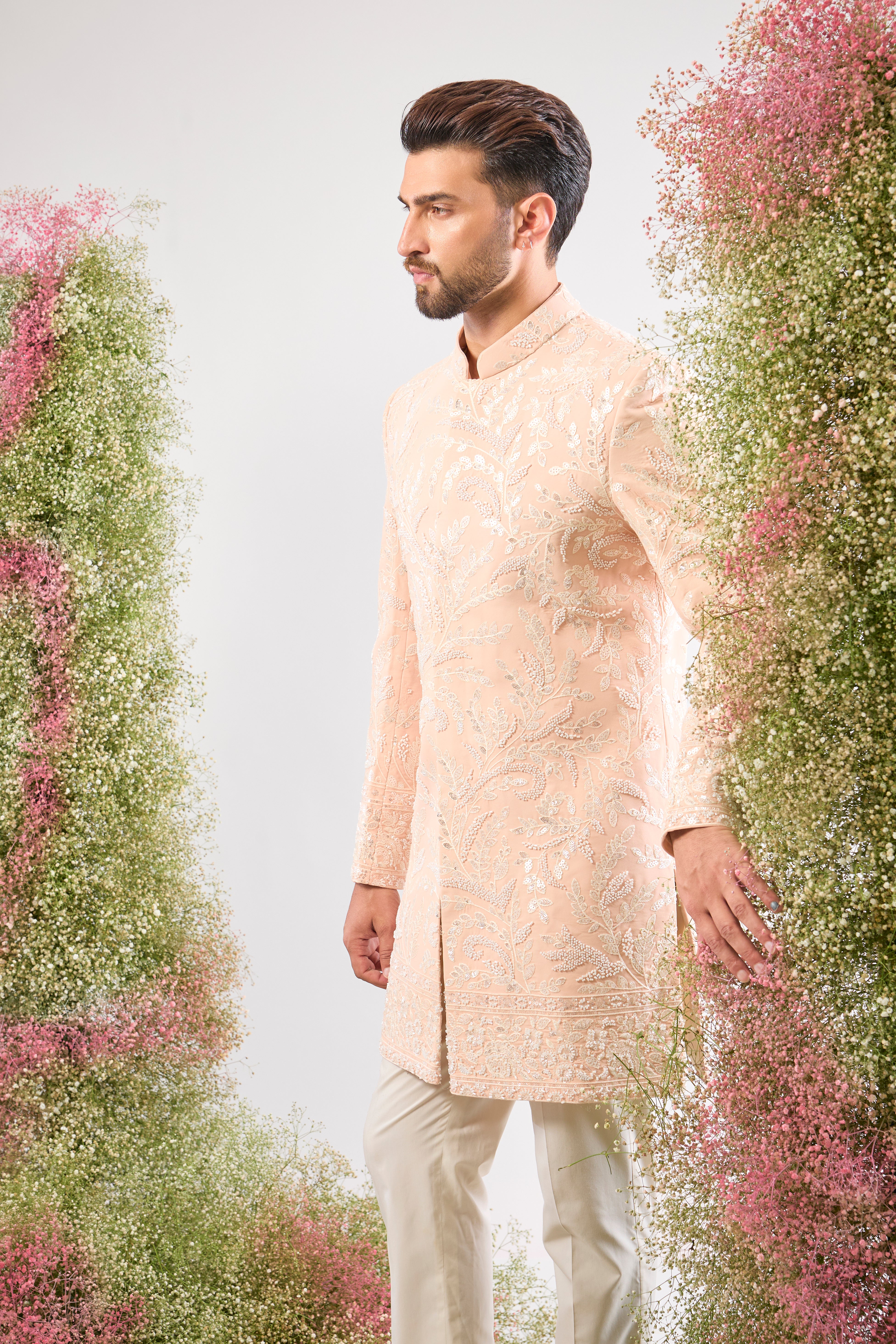 This short Sherwani showcases the impressive weight and brilliance of Heavy Cut Dana in White, perfectly complemented by detailed Floral Embroidery.