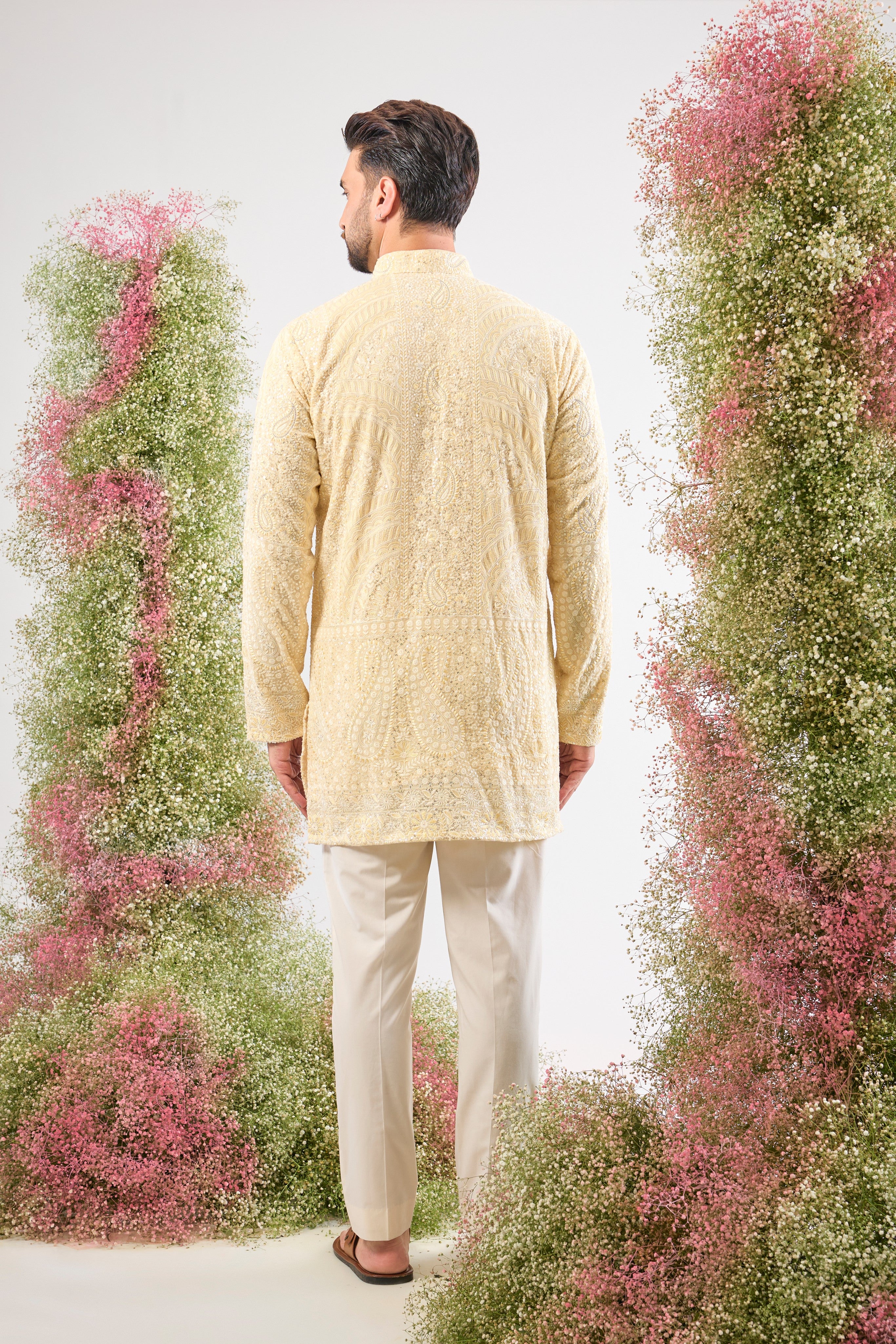 This Pastel Yellow Chikankari Short Kurta is adorned with rich Cream and Yellow Thread Work, enhancing the traditional craft.