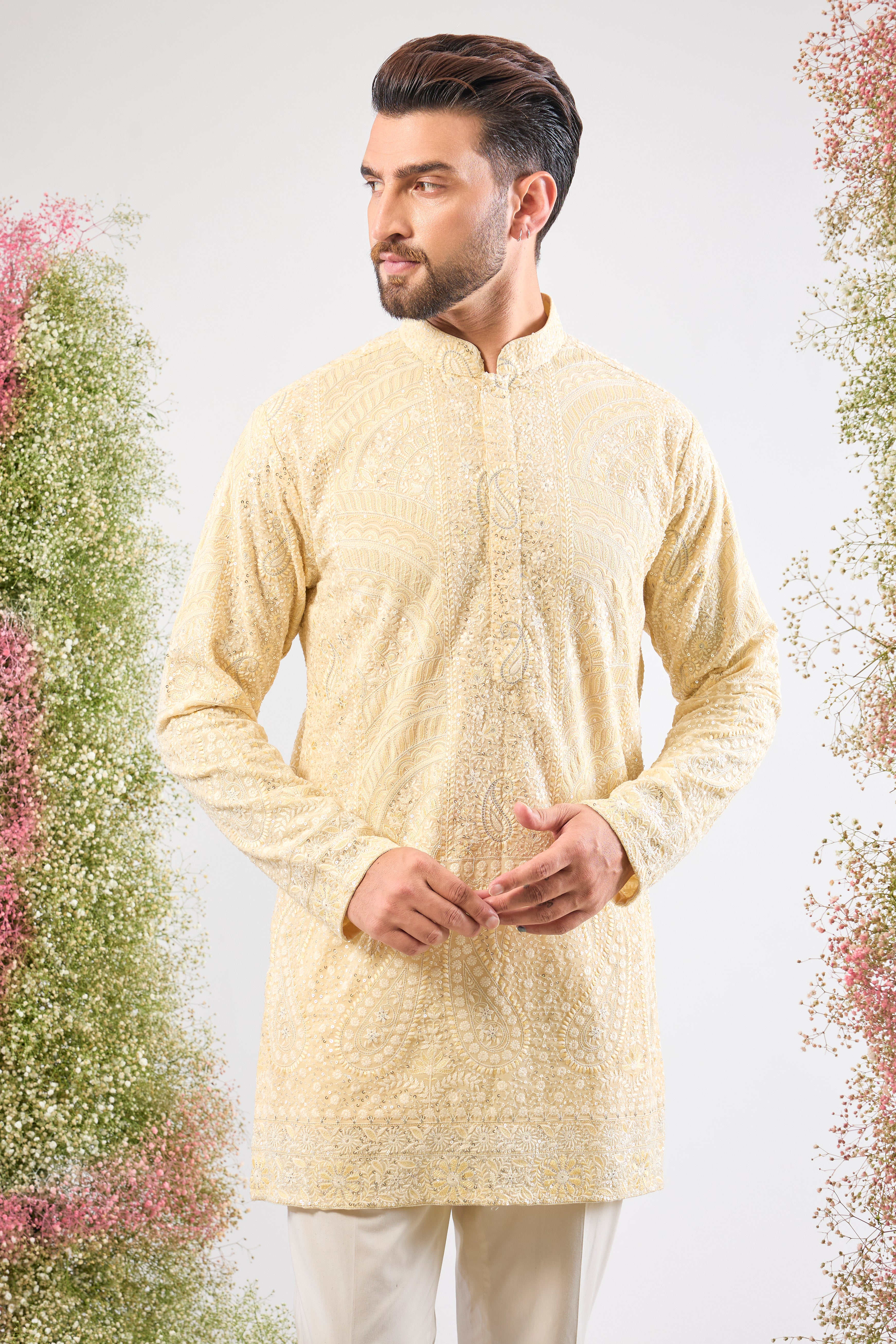 This Pastel Yellow Chikankari Short Kurta is adorned with rich Cream and Yellow Thread Work, enhancing the traditional craft.