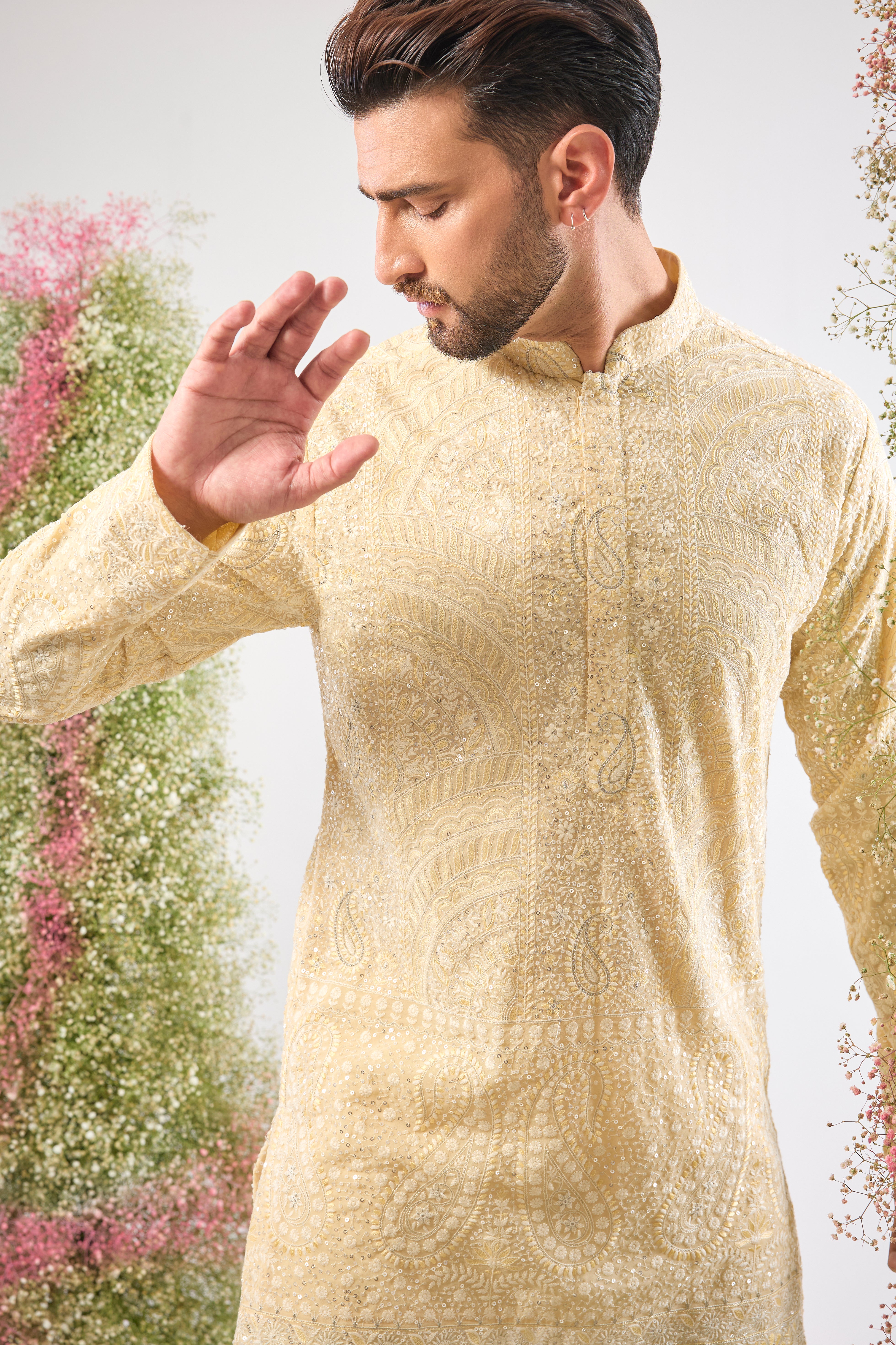 This Pastel Yellow Chikankari Short Kurta is adorned with rich Cream and Yellow Thread Work, enhancing the traditional craft.