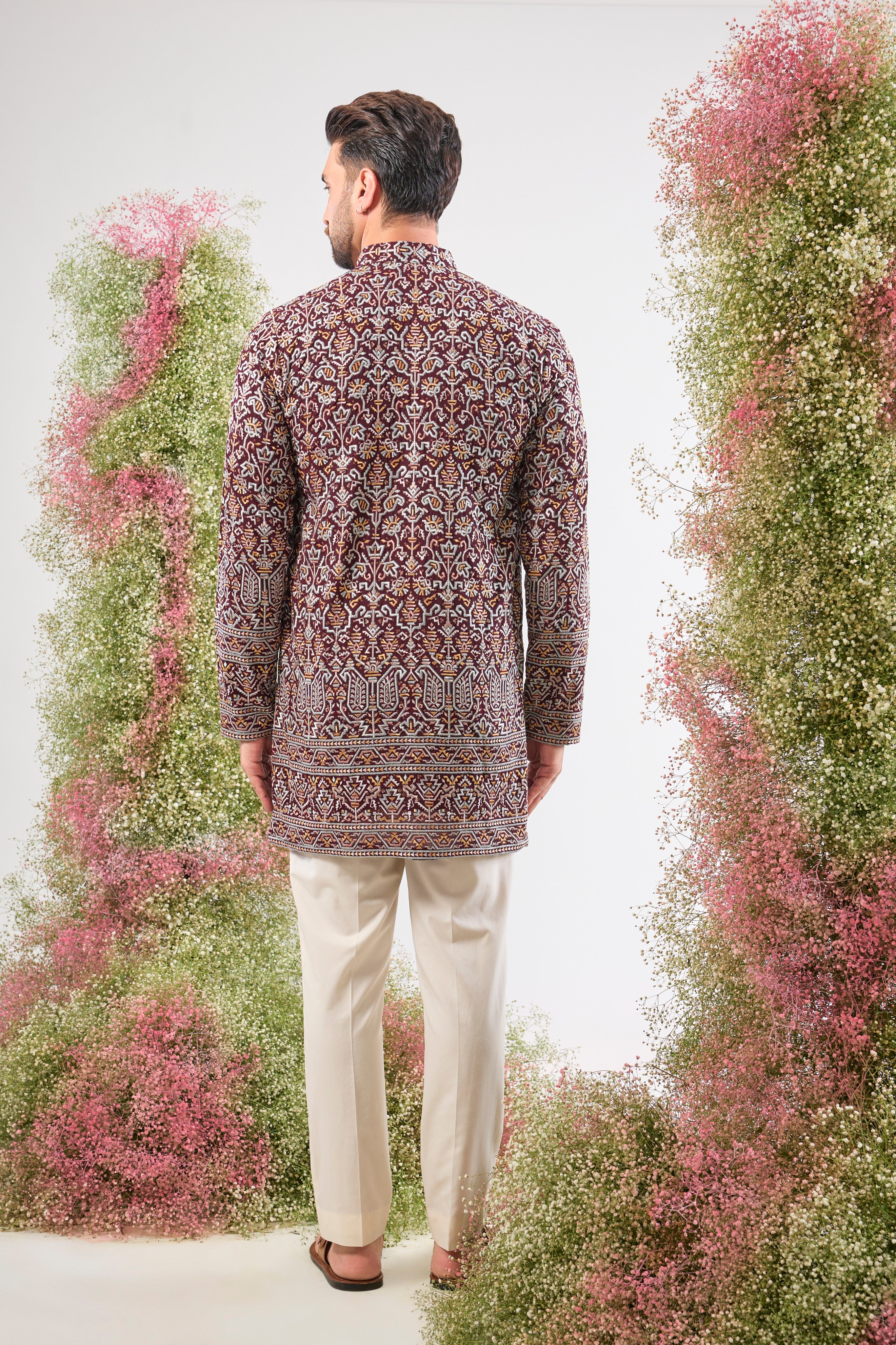 his Maroon Short Kurta showcases exquisite Intricate Multi-thread Work in a traditional pattern, beautifully highlighted by shimmering Sequin Details.