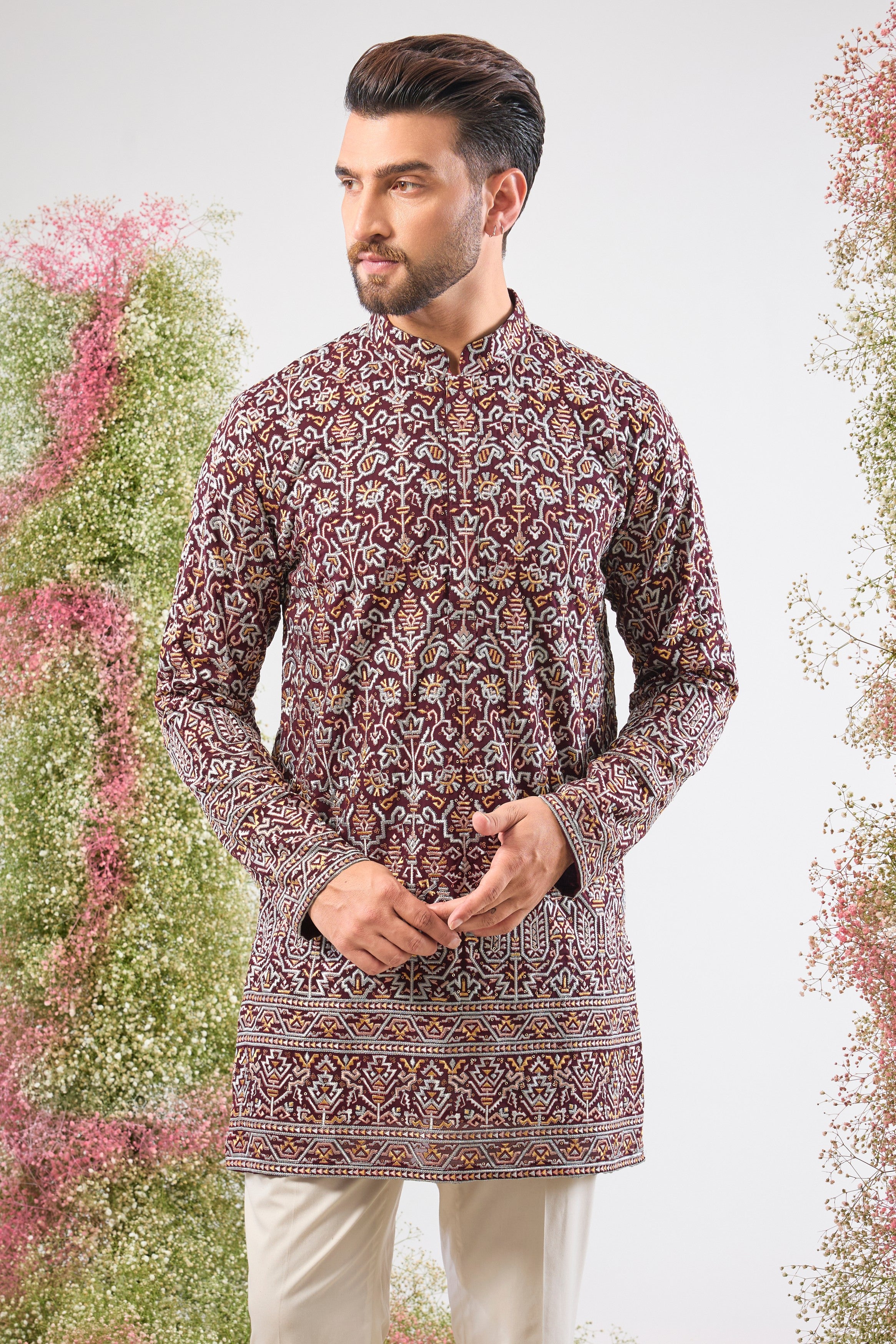 his Maroon Short Kurta showcases exquisite Intricate Multi-thread Work in a traditional pattern, beautifully highlighted by shimmering Sequin Details.