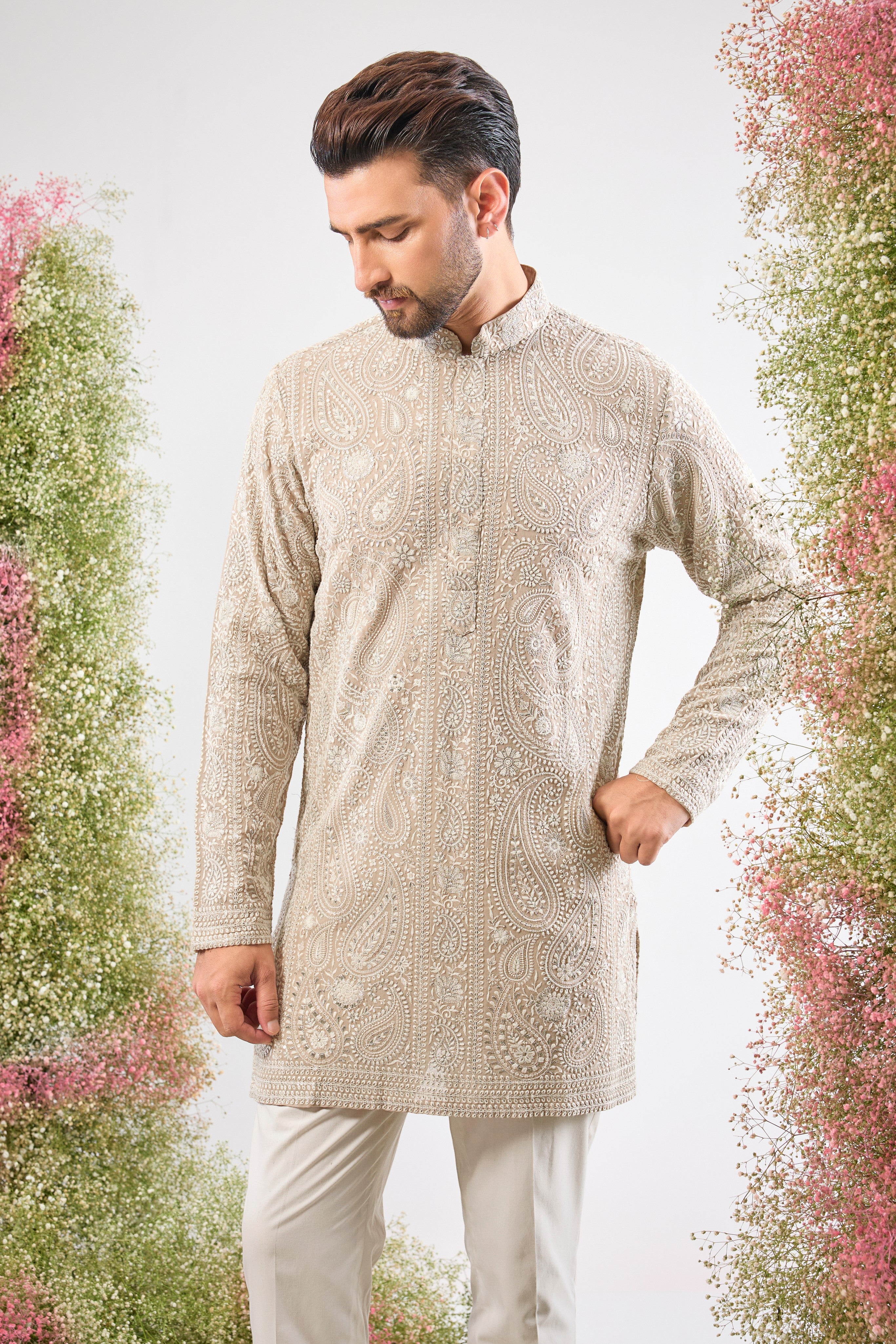 This Beige Brown Short Chikankari Kurta features exquisite Detailed Paisley Figures rendered in classic Cream Thread Work. The combination of the traditional Chikankari technique and Delicate