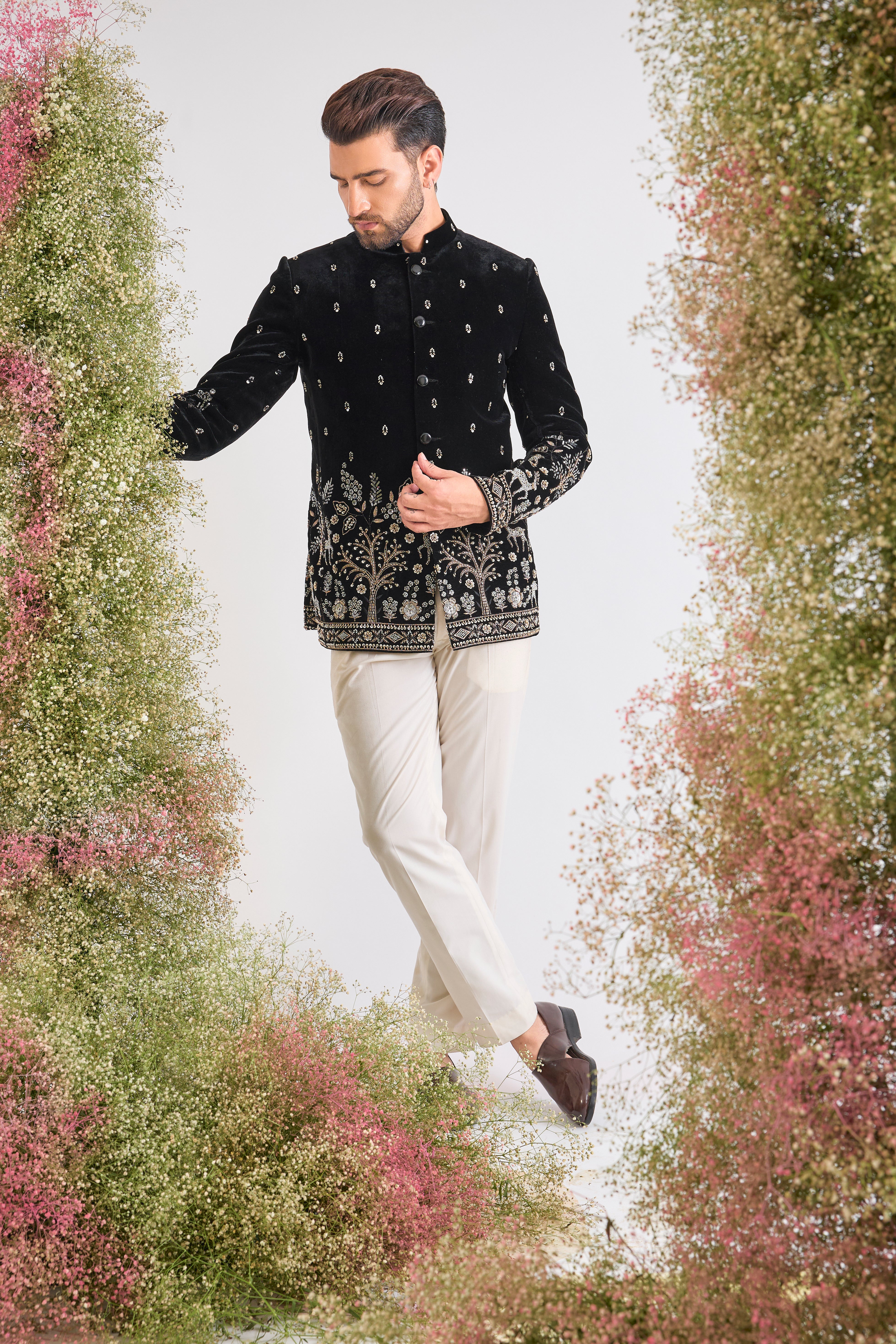 This Black Bandhgala showcases extraordinary, concentrated Handwork featuring shimmering Sequins, textural Beads, and reflective Cut Dana.