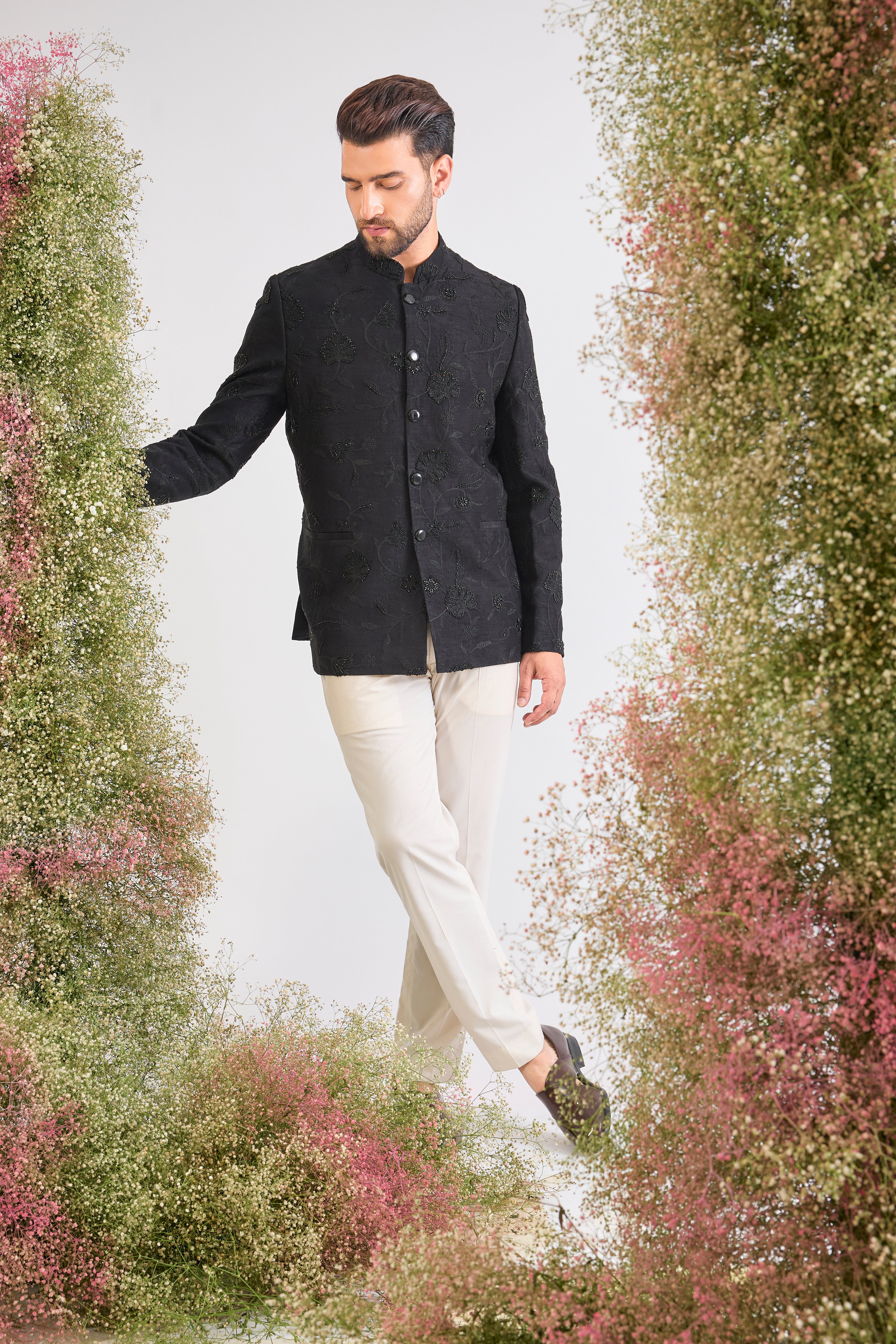 This Black Bandhgala showcases Delicate Floral Embroidery expertly highlighted with sparkling Cut Dana. The craftsmanship provides rich detail, while the Sleek Metal Buttons ensure a sharp, contemporary finish.