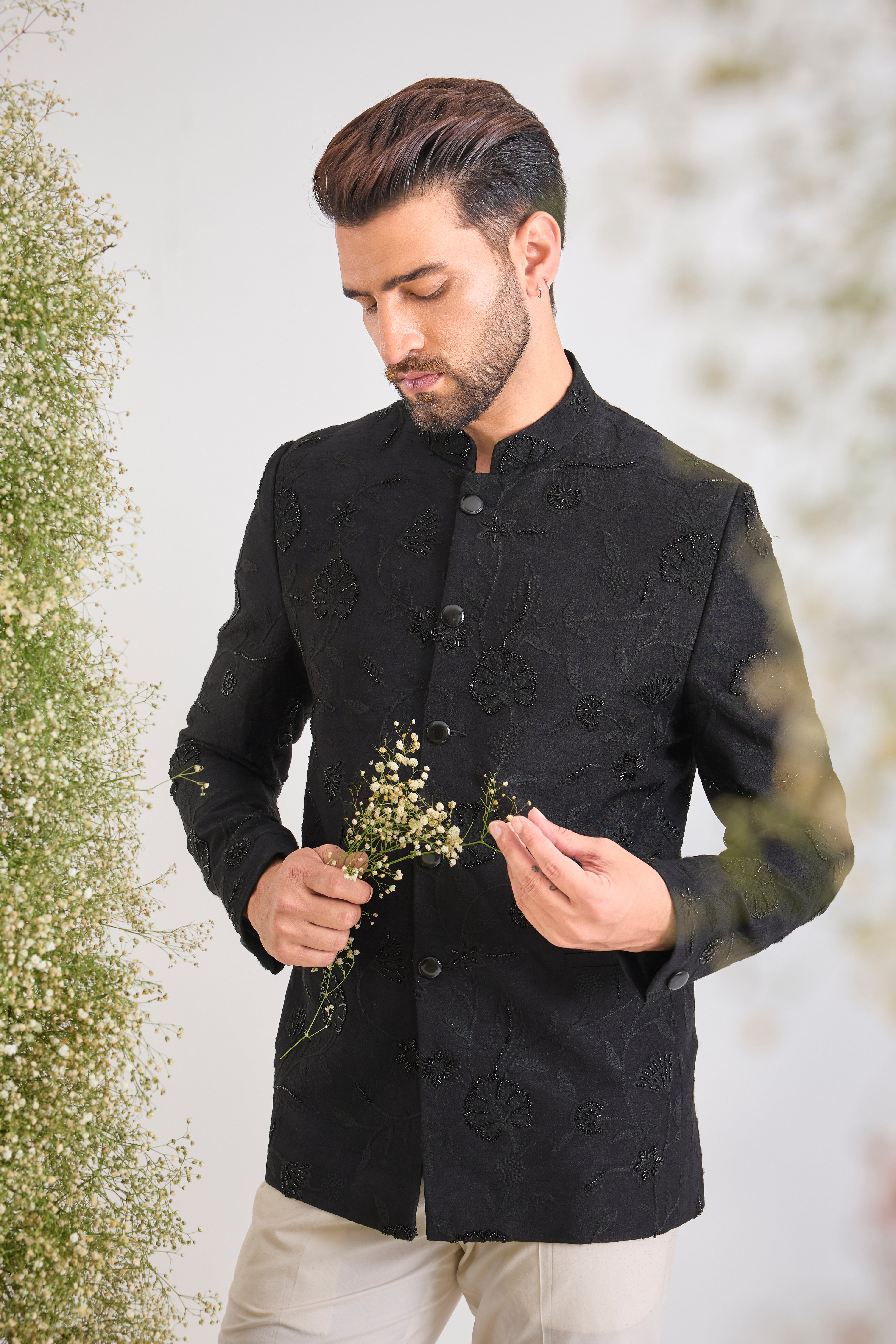 This Black Bandhgala showcases Delicate Floral Embroidery expertly highlighted with sparkling Cut Dana. The craftsmanship provides rich detail, while the Sleek Metal Buttons ensure a sharp, contemporary finish.