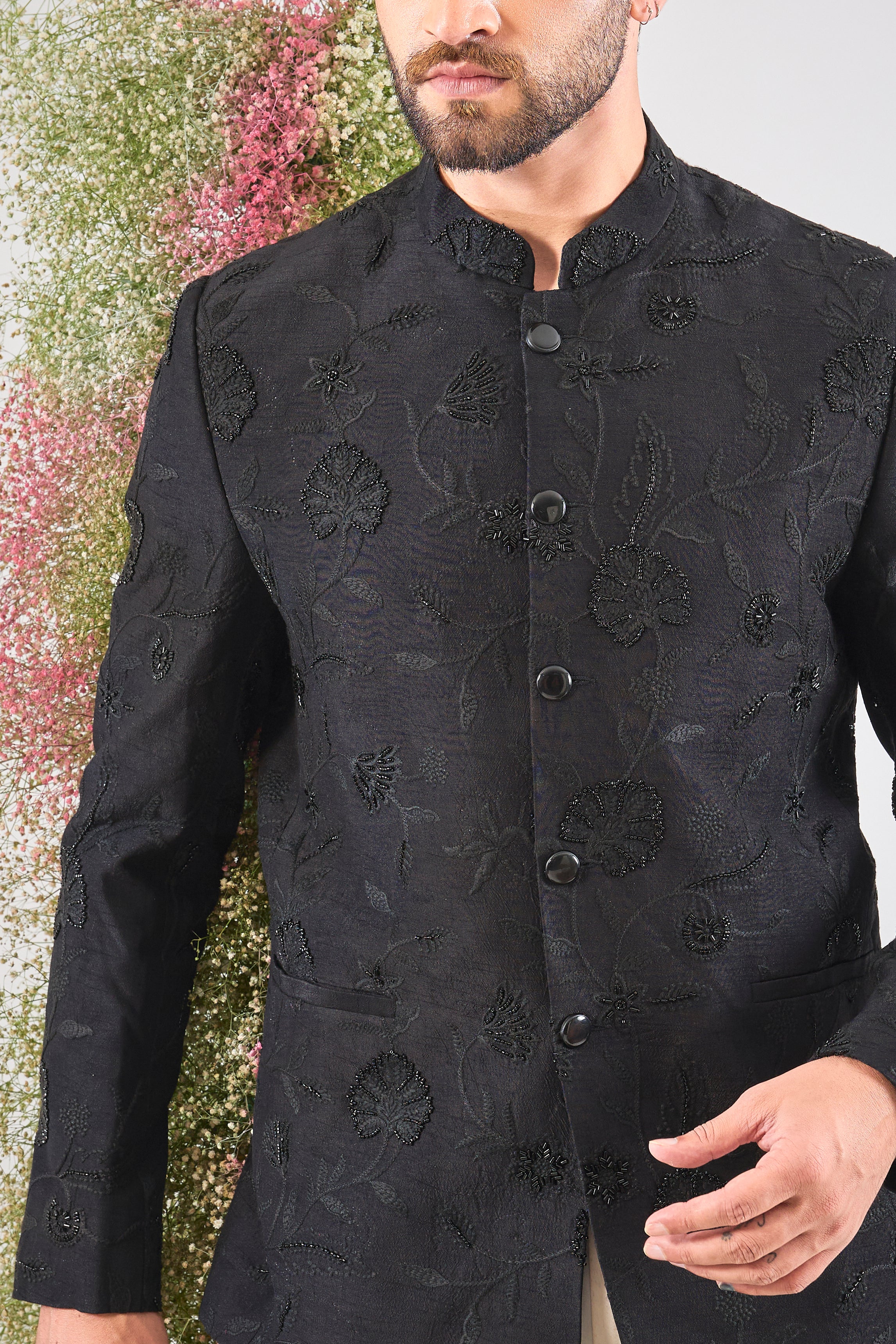 This Black Bandhgala showcases Delicate Floral Embroidery expertly highlighted with sparkling Cut Dana. The craftsmanship provides rich detail, while the Sleek Metal Buttons ensure a sharp, contemporary finish.