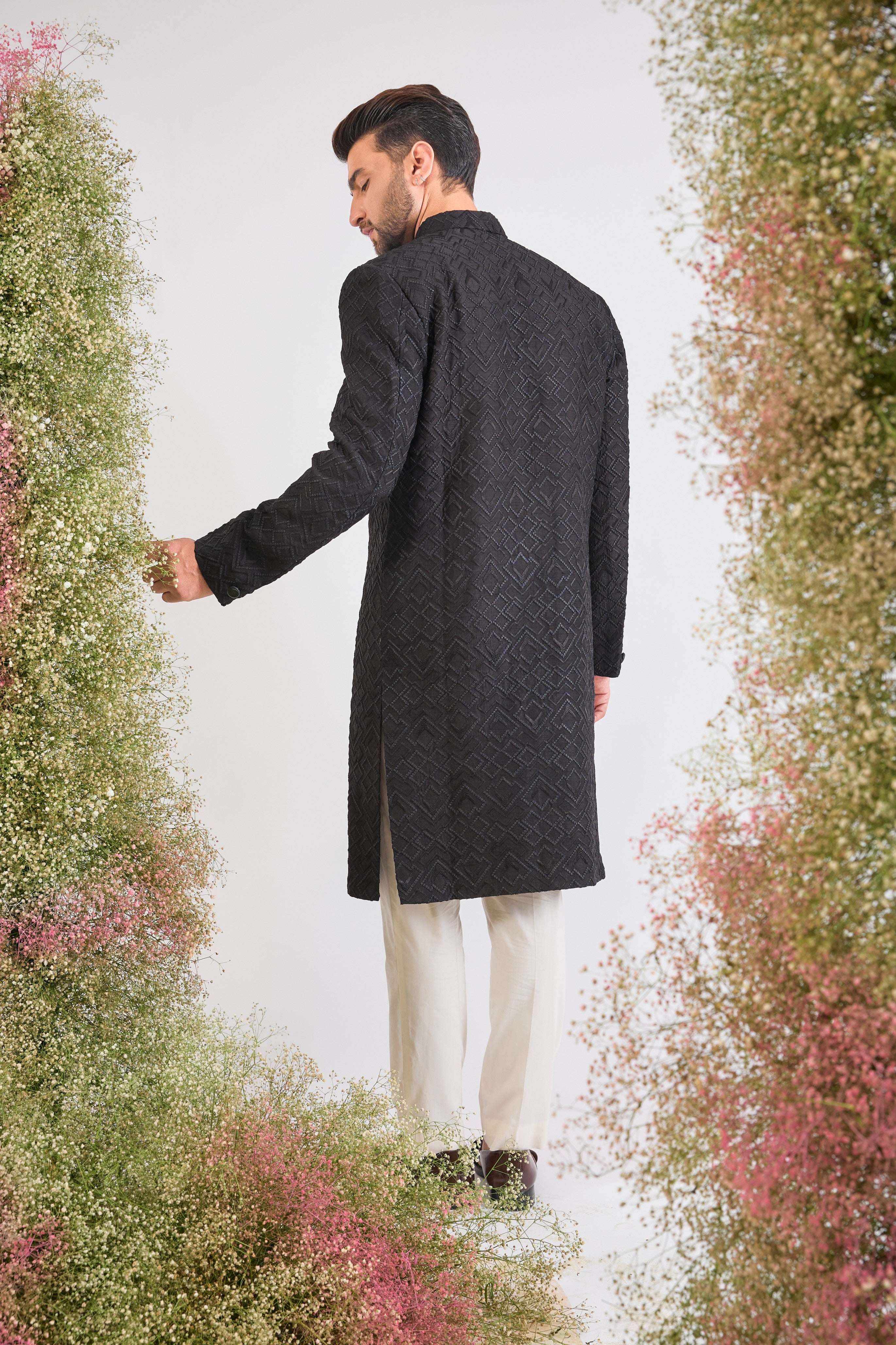 This Sherwani showcases a striking Geometrical Design through Tone-to-Tone Heavy Thread Work, offering unmatched richness and texture.