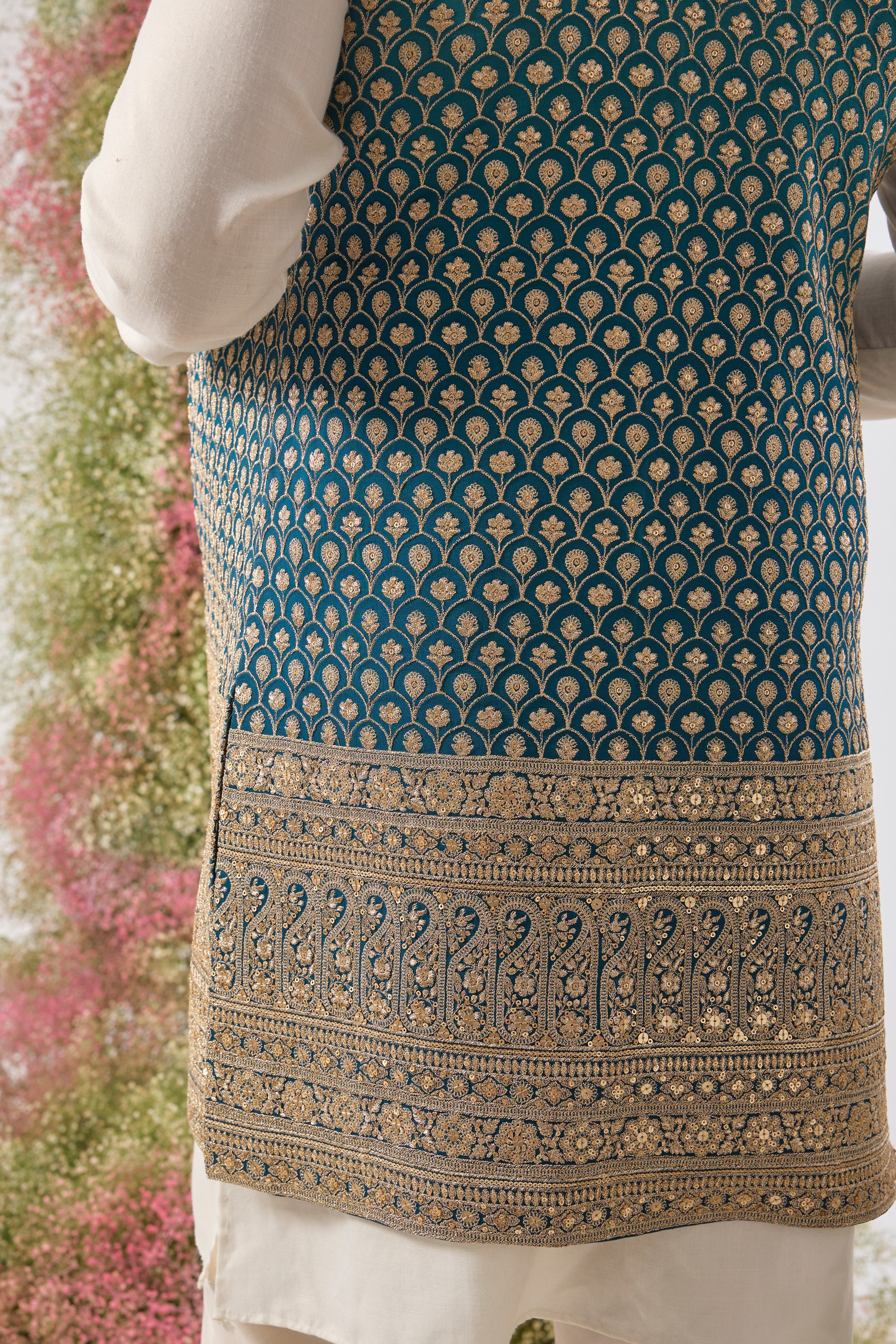 his Ombre Shaded Blue Long Open Jacket showcases an exquisite gradient and is lavishly detailed with Heavy Zari Work, providing depth and shimmer.