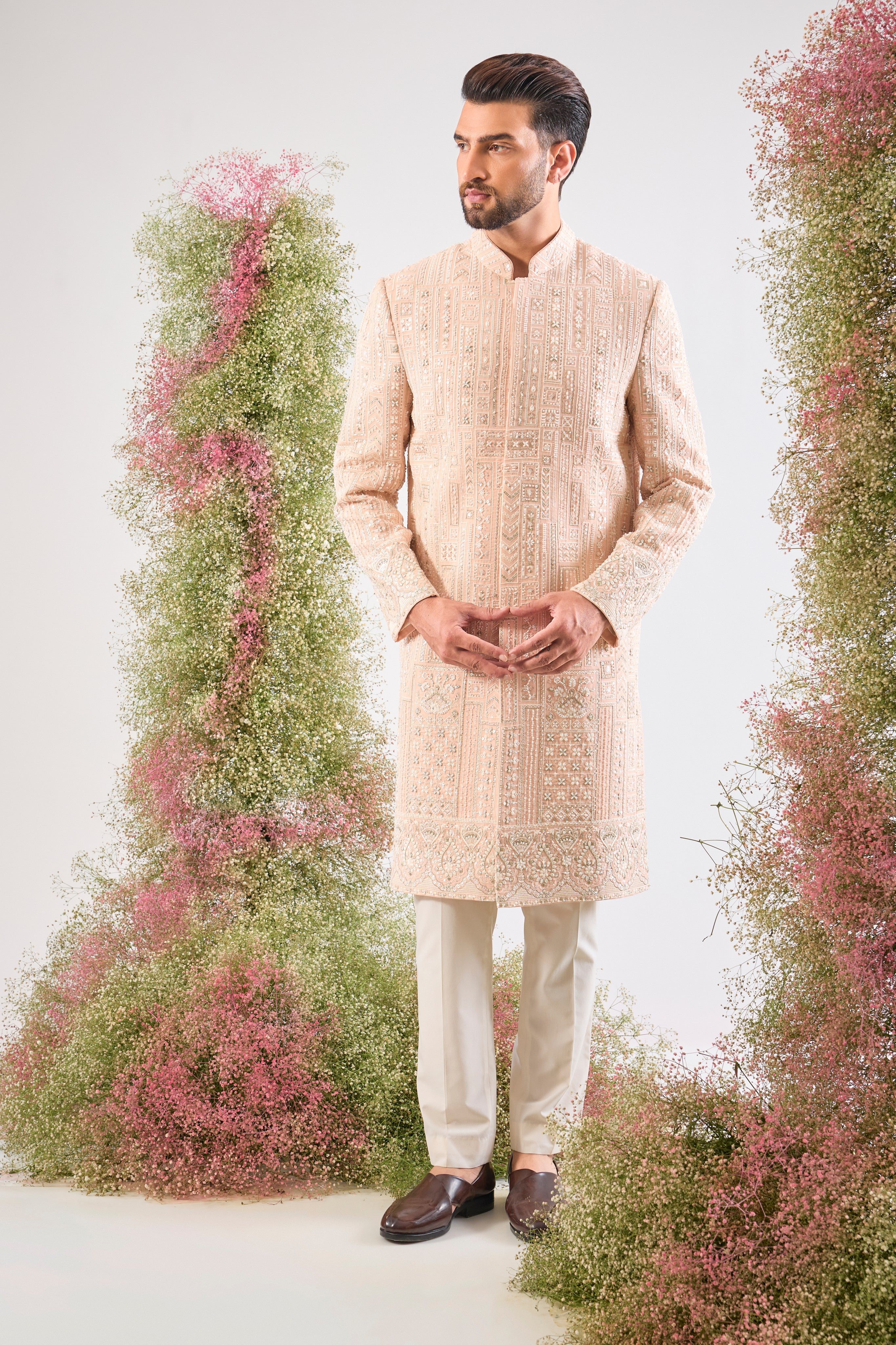 This Pink Sherwani showcases beautiful Geometrical Embroidery, with every line and angle accentuated by dazzling Cut Dana, reflective Sequins, and rich Zari Touches.
