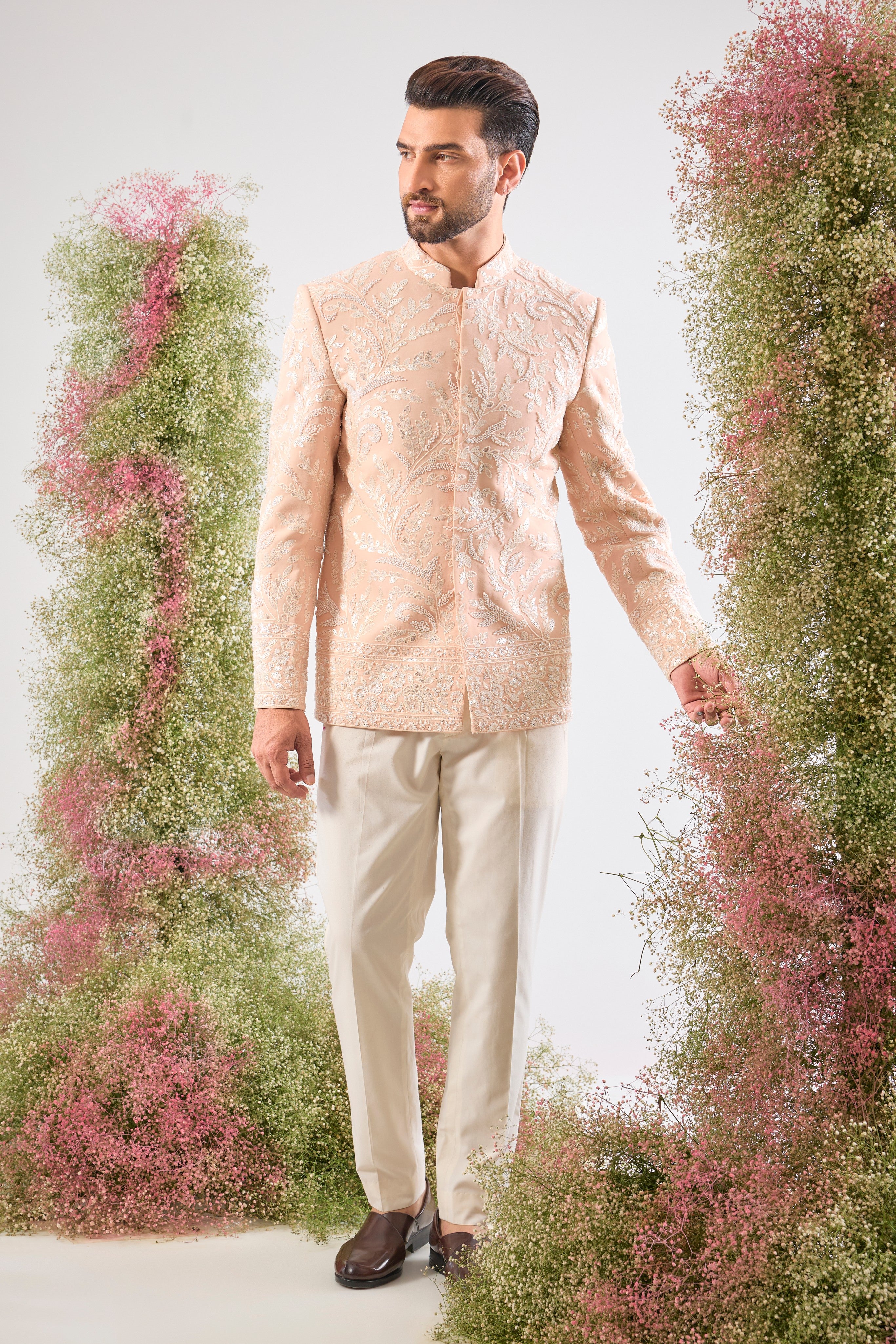 This Hand Embroidered Bandhgala features rich, textural detail where Intricate Floral Embroidery is lavishly decorated with brilliant White Cut Dana and Sequins. The subtle yet