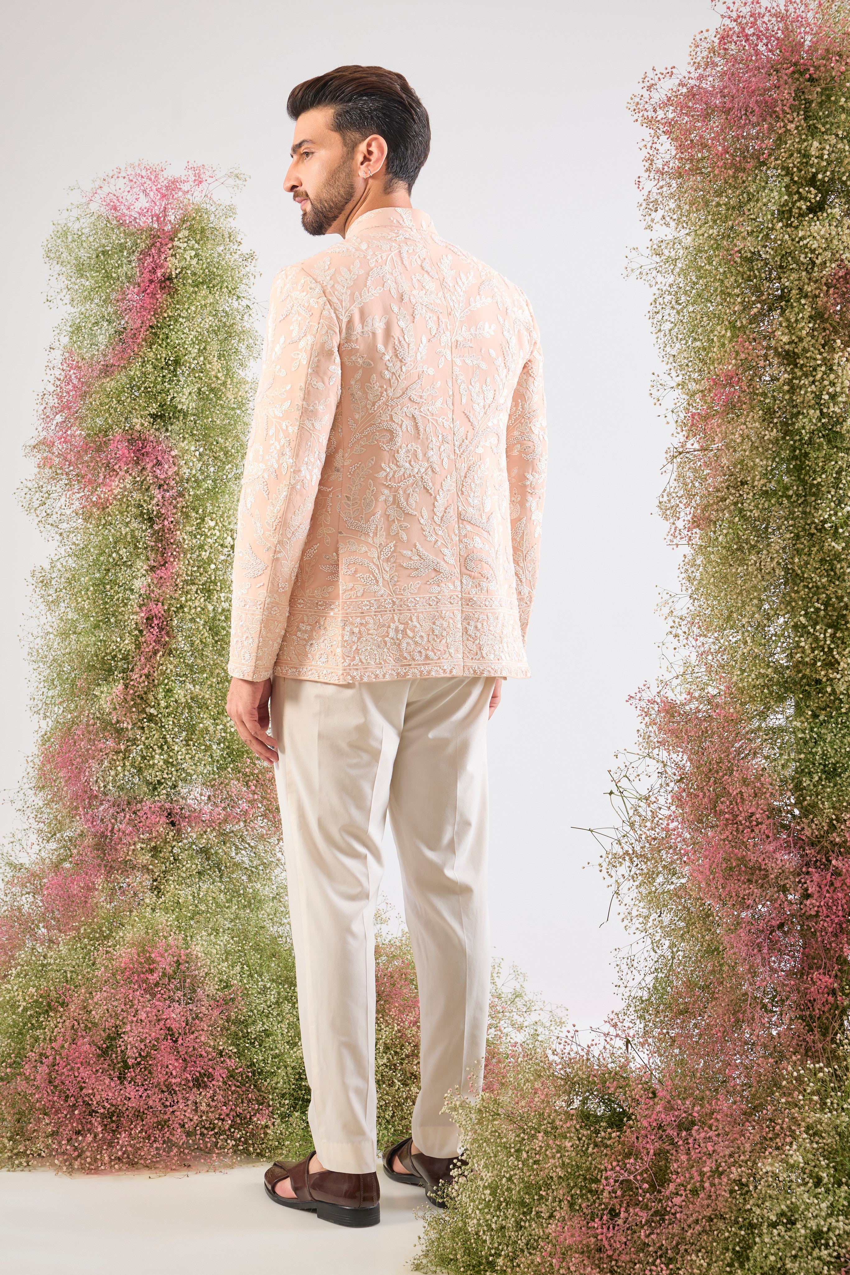 This Hand Embroidered Bandhgala features rich, textural detail where Intricate Floral Embroidery is lavishly decorated with brilliant White Cut Dana and Sequins.