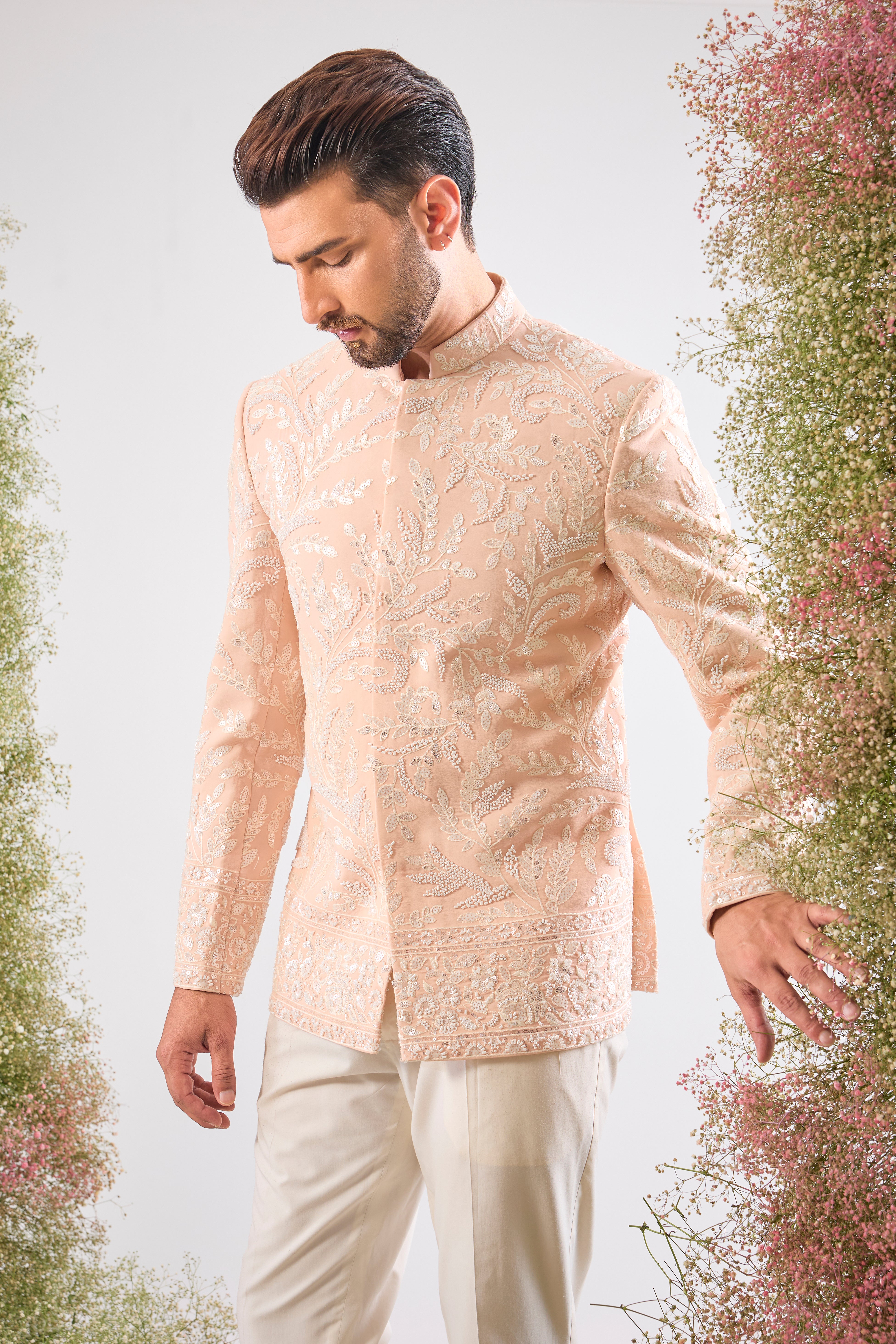This Hand Embroidered Bandhgala features rich, textural detail where Intricate Floral Embroidery is lavishly decorated with brilliant White Cut Dana and Sequins. The subtle yet