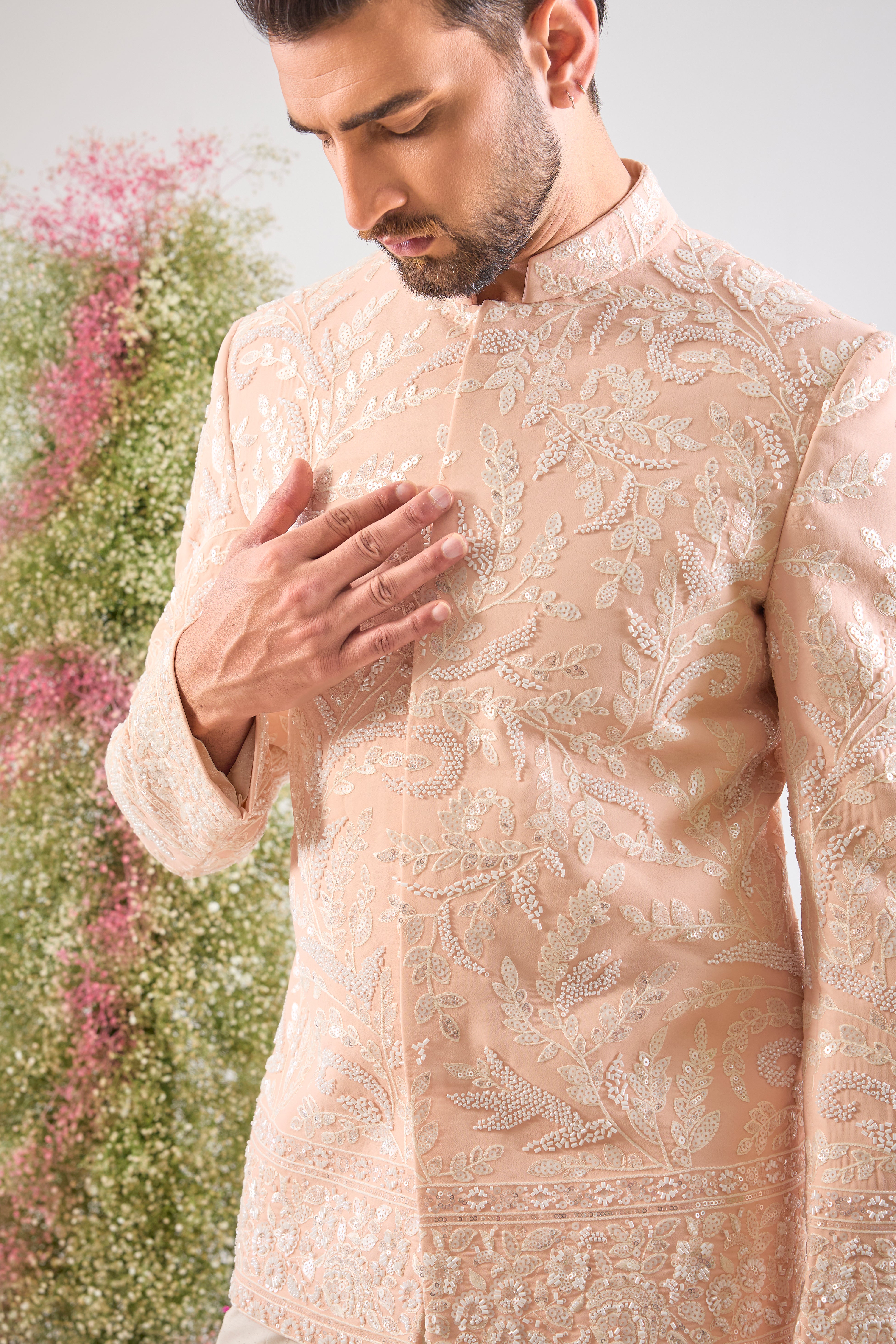 This Hand Embroidered Bandhgala features rich, textural detail where Intricate Floral Embroidery is lavishly decorated with brilliant White Cut Dana and Sequins. The subtle yet