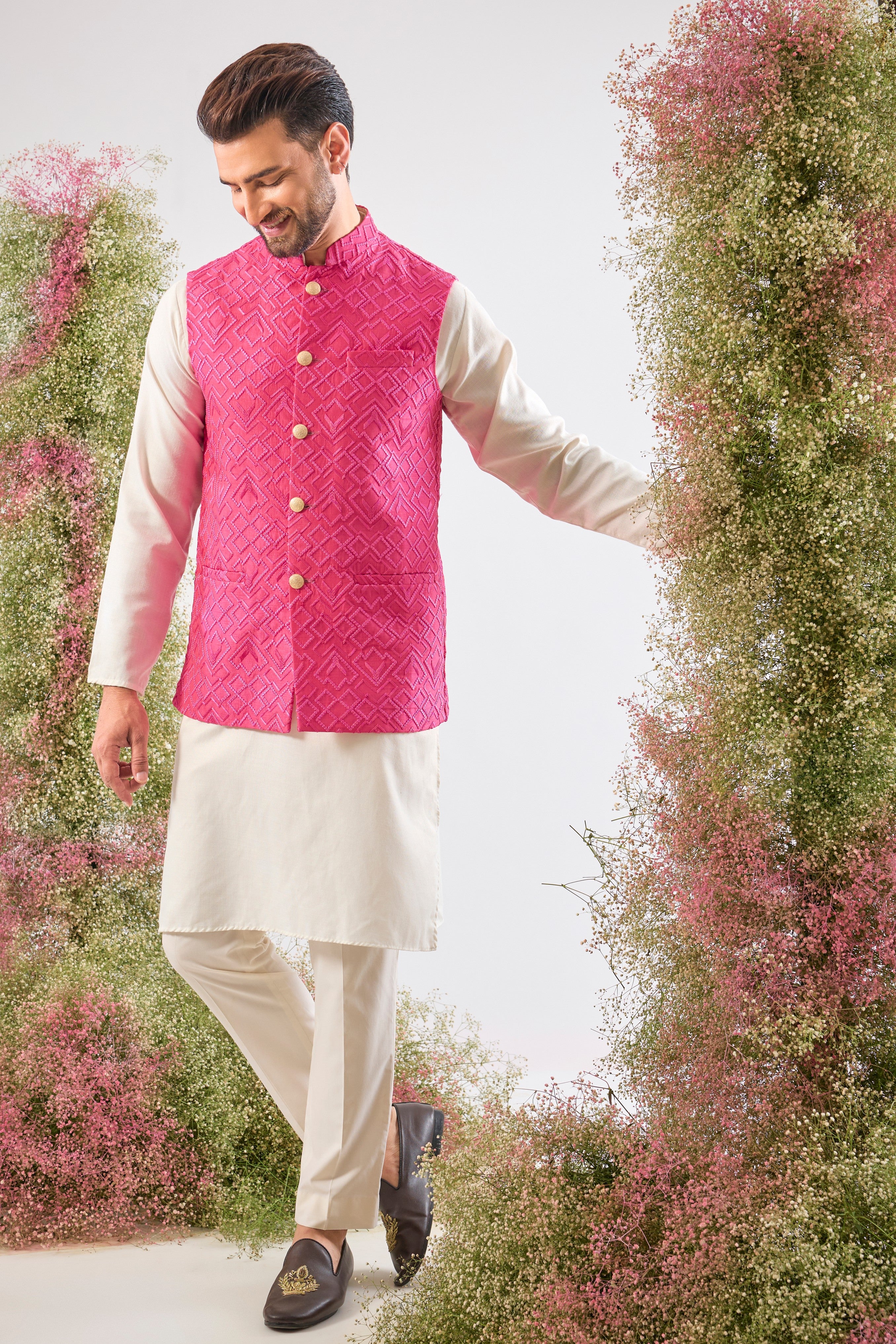 This Hot Pink Nehru Jacket showcases intense Heavy Thread Work in a sharp Geometrical Pattern, creating unparalleled richness and depth. This jacket is the perfect layering piece to infuse energy and sophistication into any formal ensemble