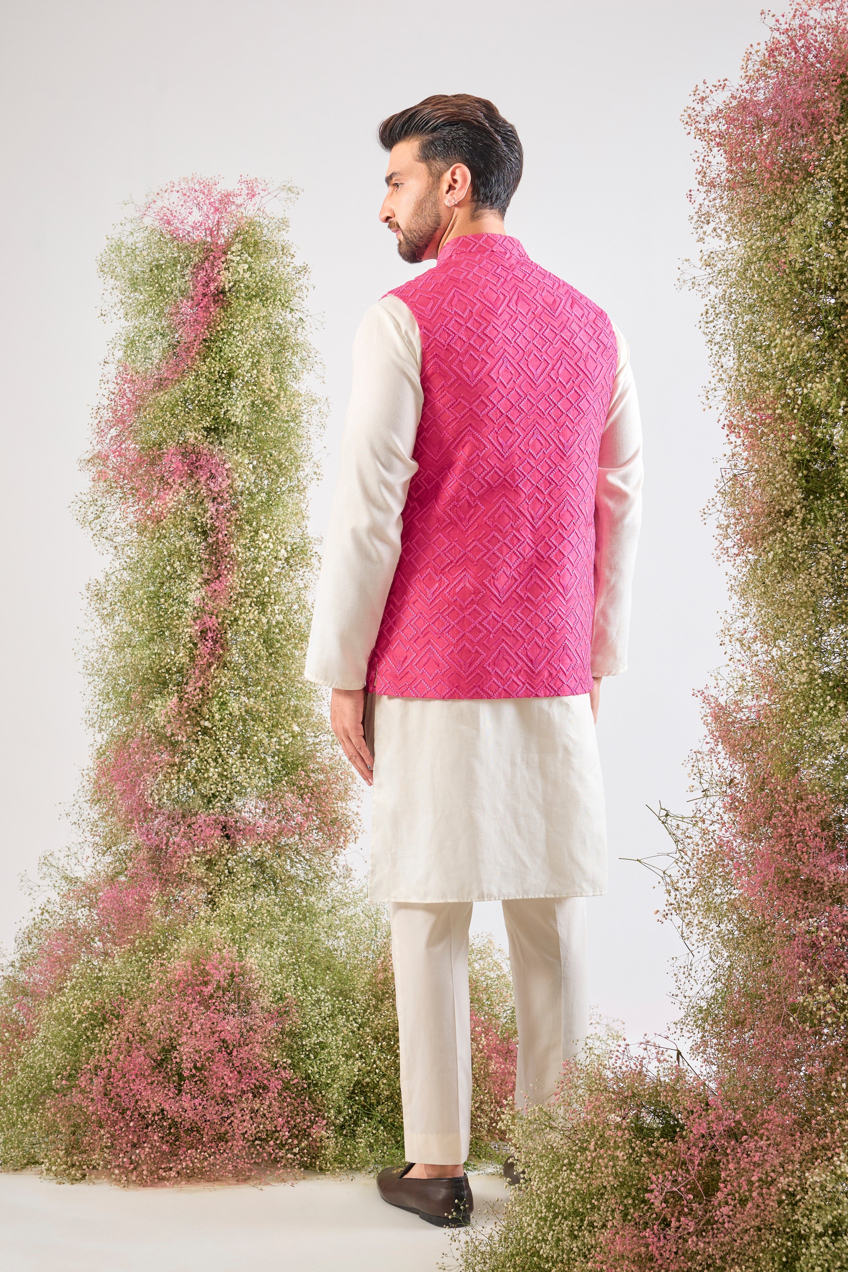 This Hot Pink Nehru Jacket showcases intense Heavy Thread Work in a sharp Geometrical Pattern, creating unparalleled richness and depth. This jacket is the perfect layering piece to infuse energy and sophistication into any formal ensemble