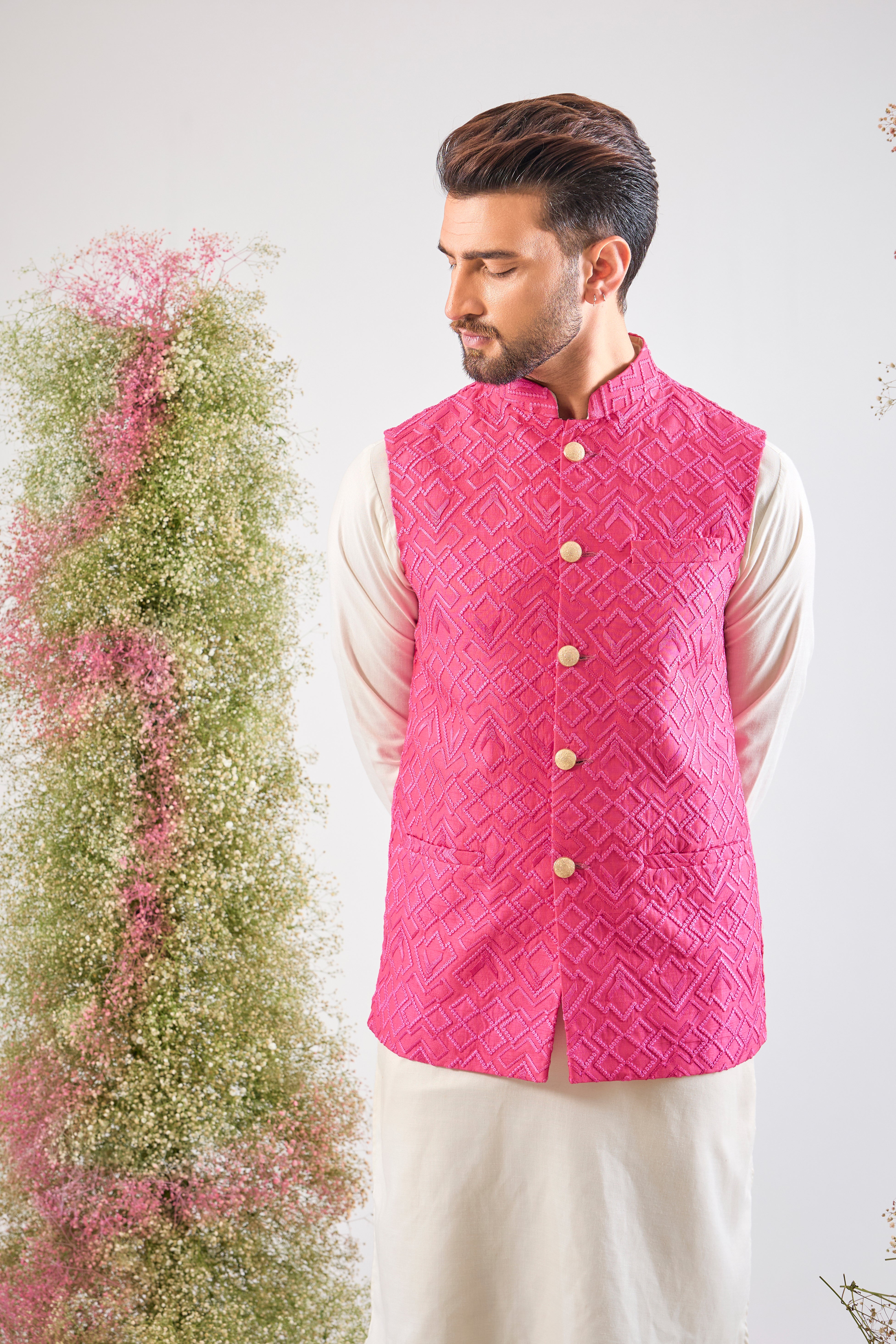This Hot Pink Nehru Jacket showcases intense Heavy Thread Work in a sharp Geometrical Pattern, creating unparalleled richness and depth. This jacket is the perfect layering piece to infuse energy and sophistication into any formal ensemble