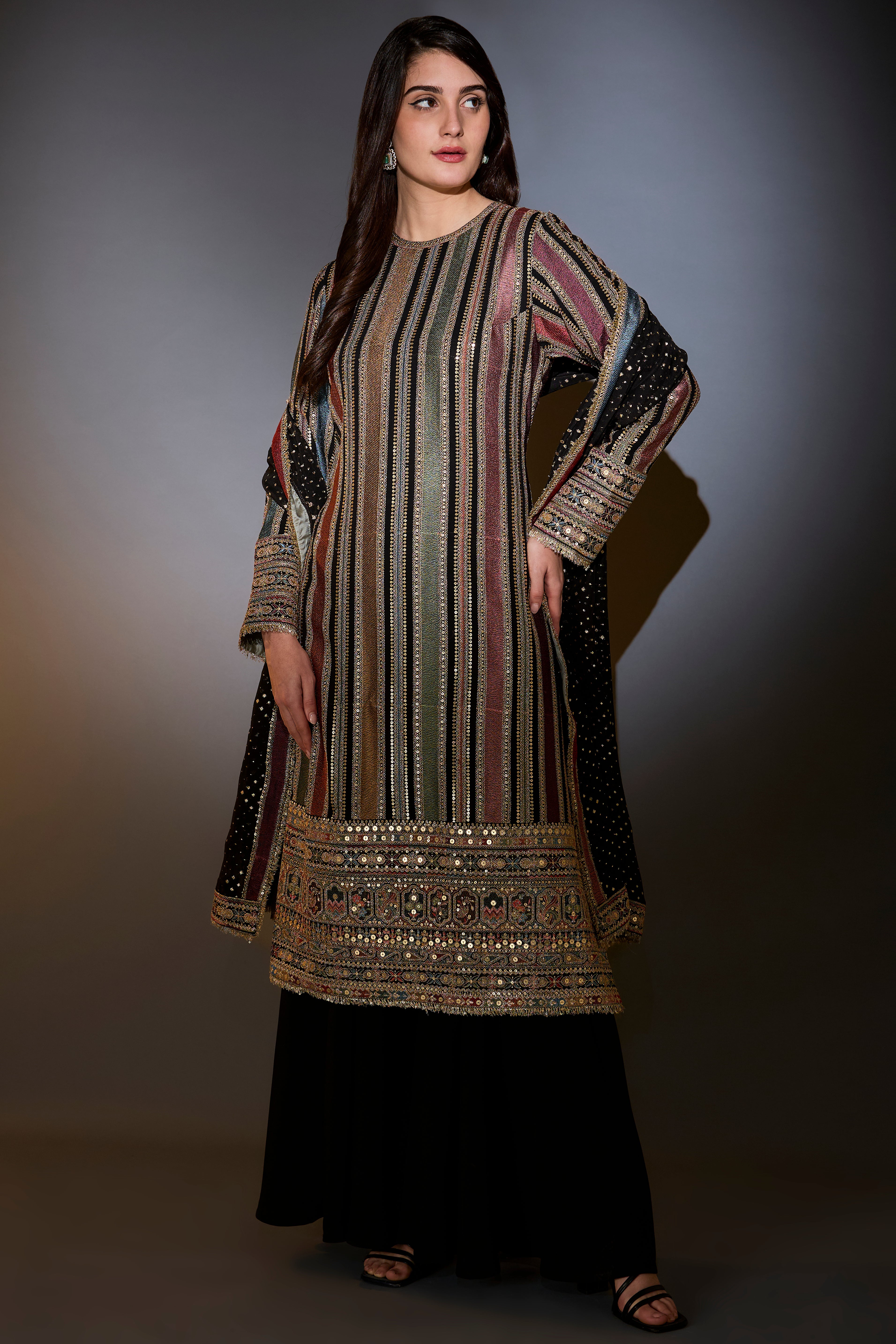 Multi-color striped suit with intricately done thread and zari work paired with sharara and dupatta.