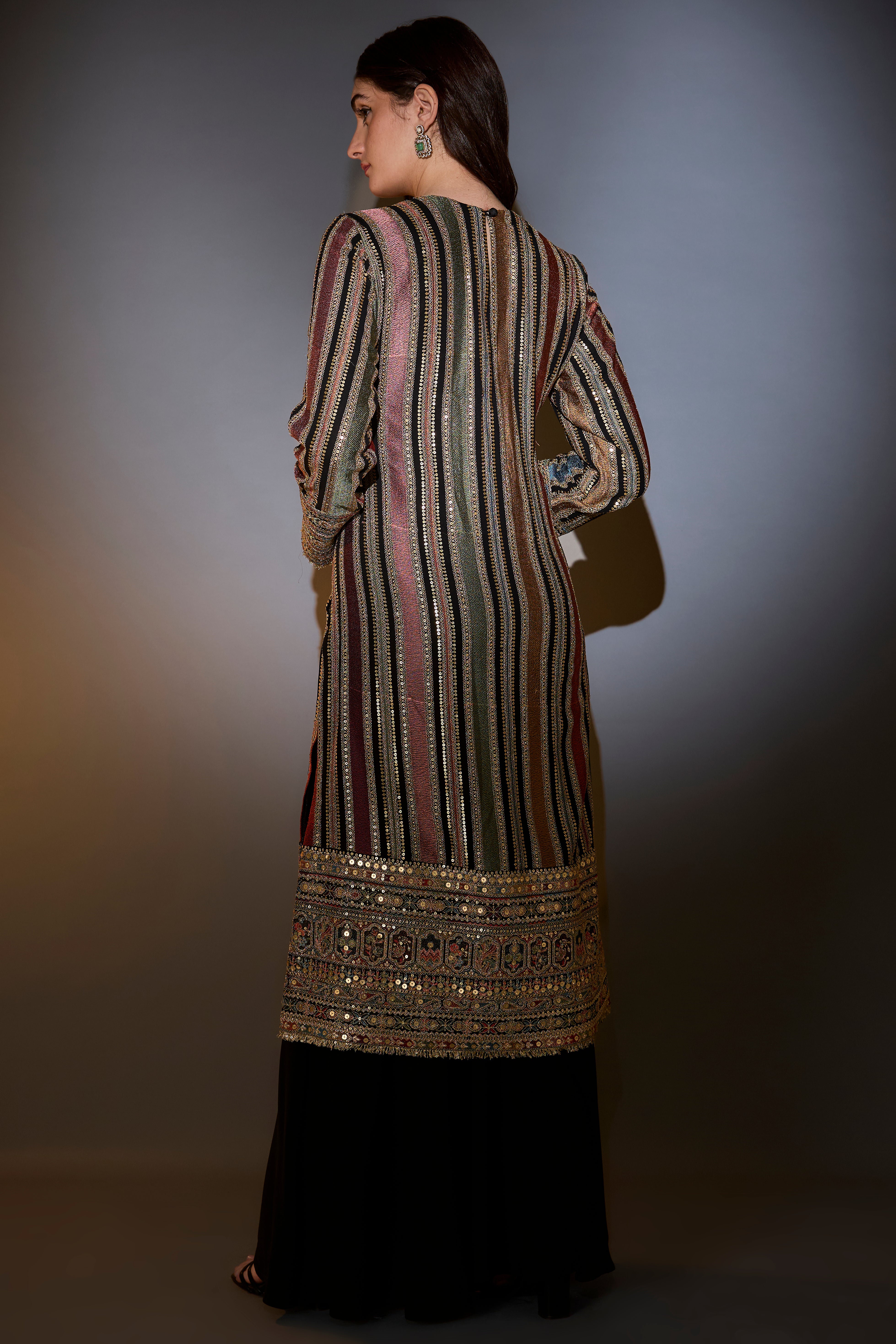 Multi-color striped suit with intricately done thread and zari work paired with sharara and dupatta.