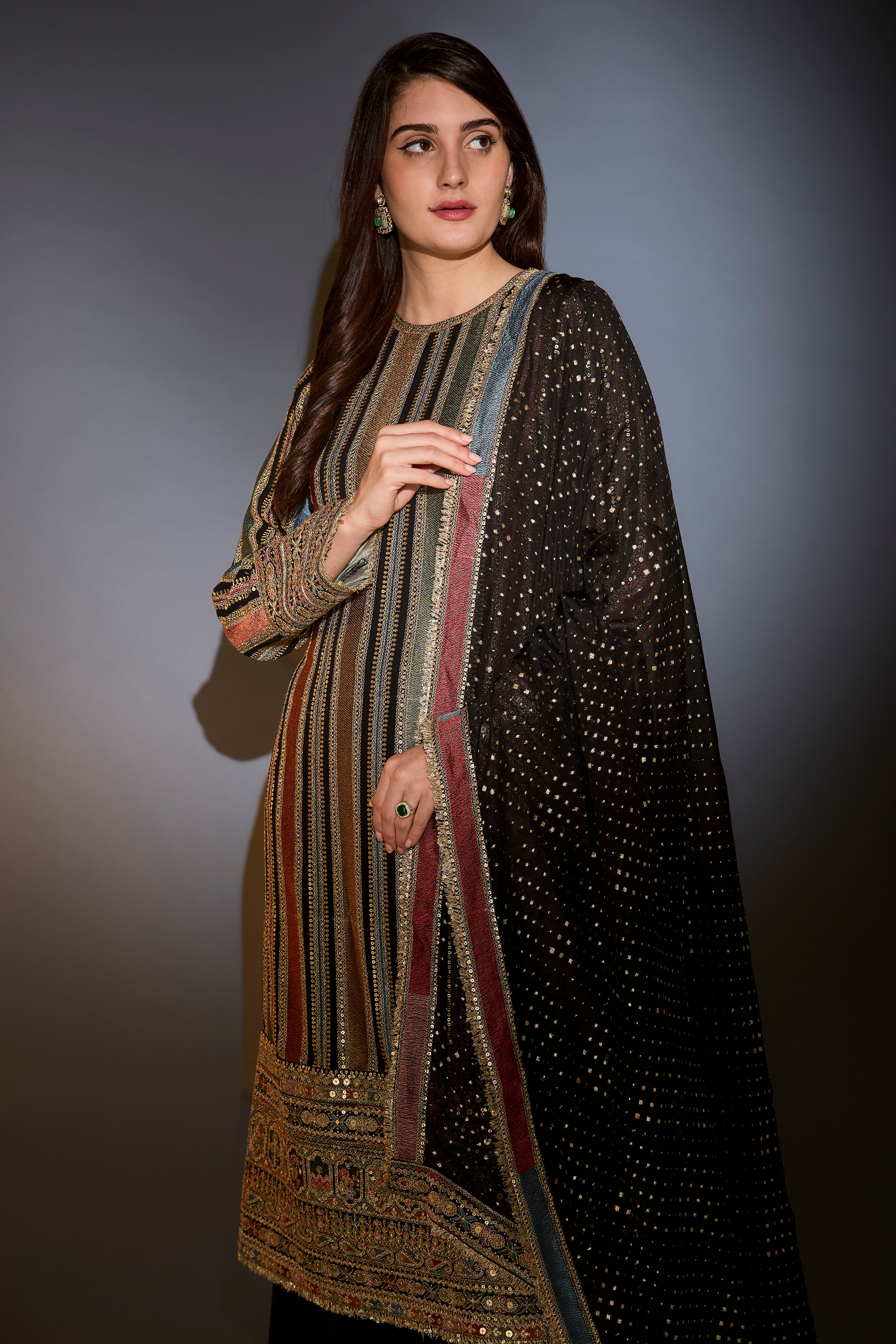 Multi-color striped suit with intricately done thread and zari work paired with sharara and dupatta.