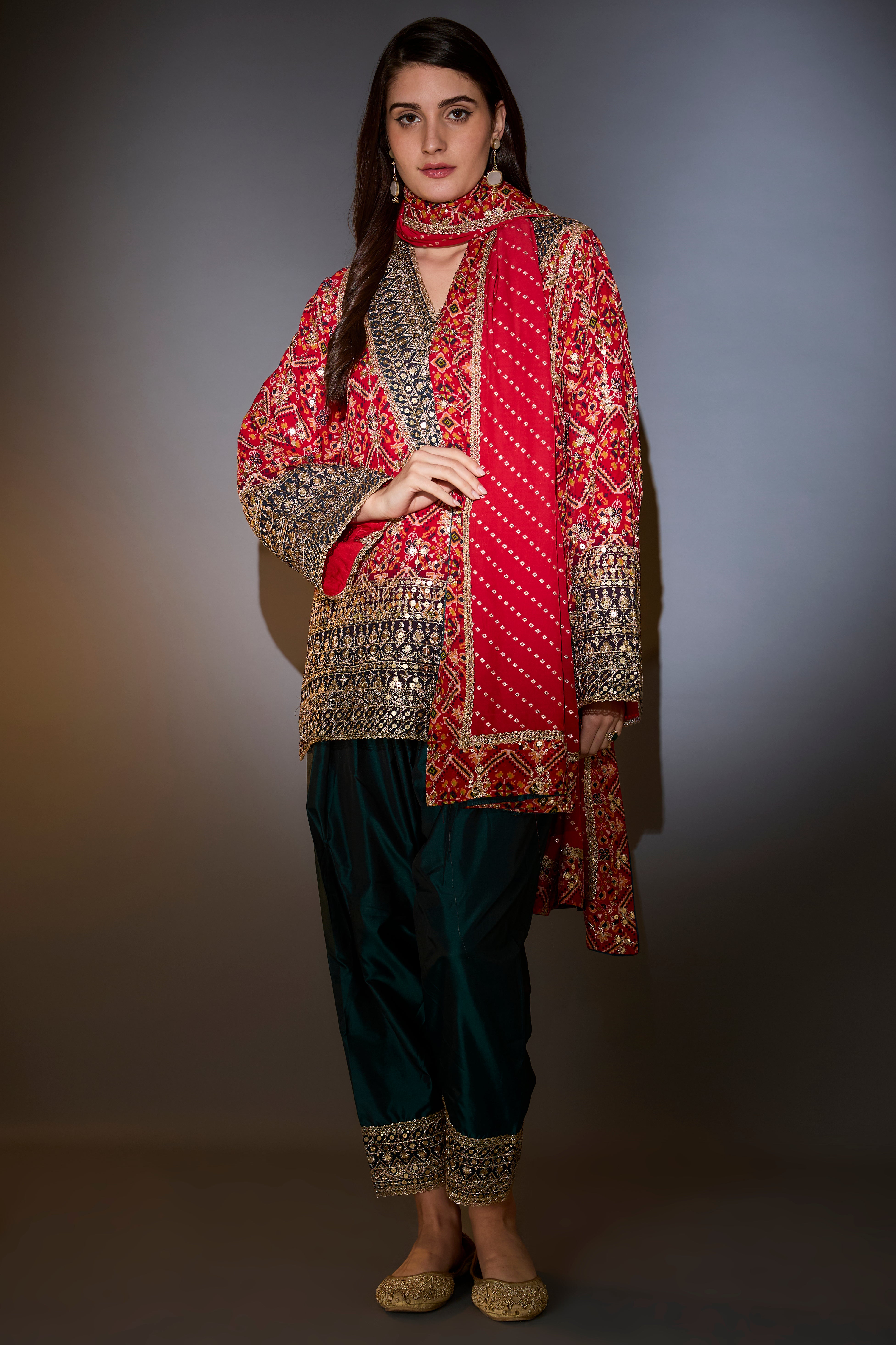 Suit set with short bandhni kurta with intricate aari work, paired with banarsi dupatta with borders and silk salwar.