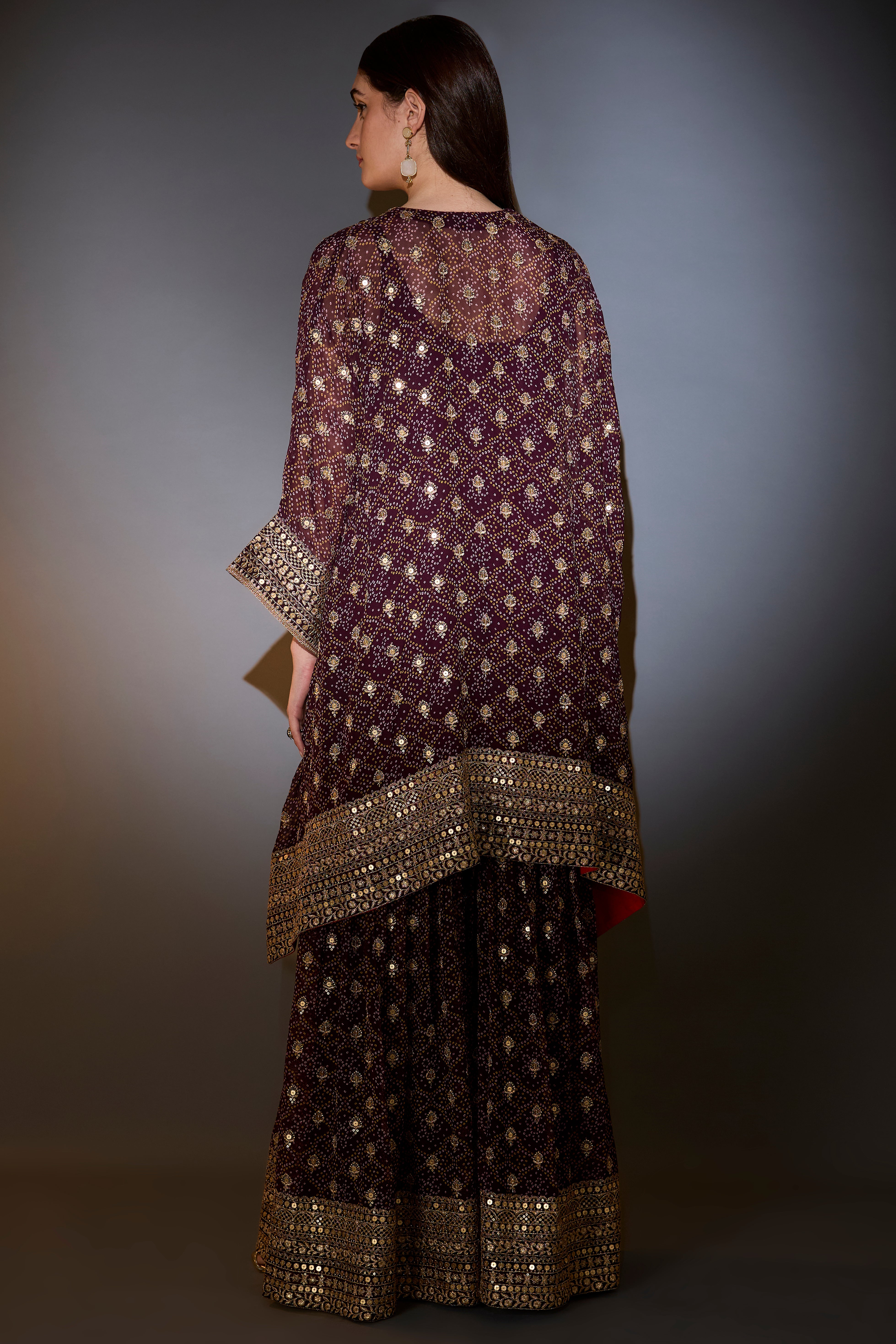 Wine kaftan with sharara with intricate aari and sequins work on the neck, ghera and bottom.