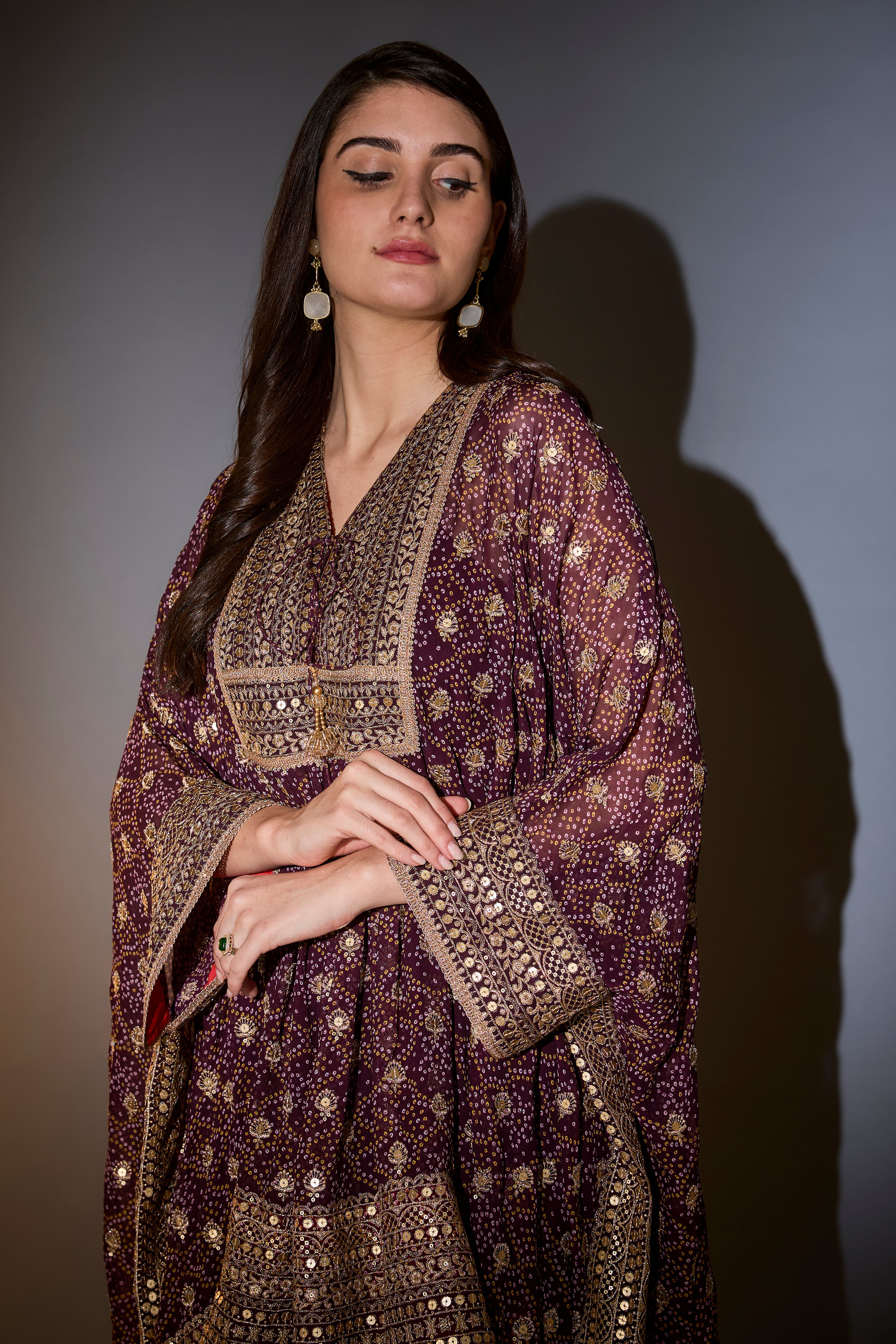 Wine kaftan with sharara with intricate aari and sequins work on the neck, ghera and bottom.