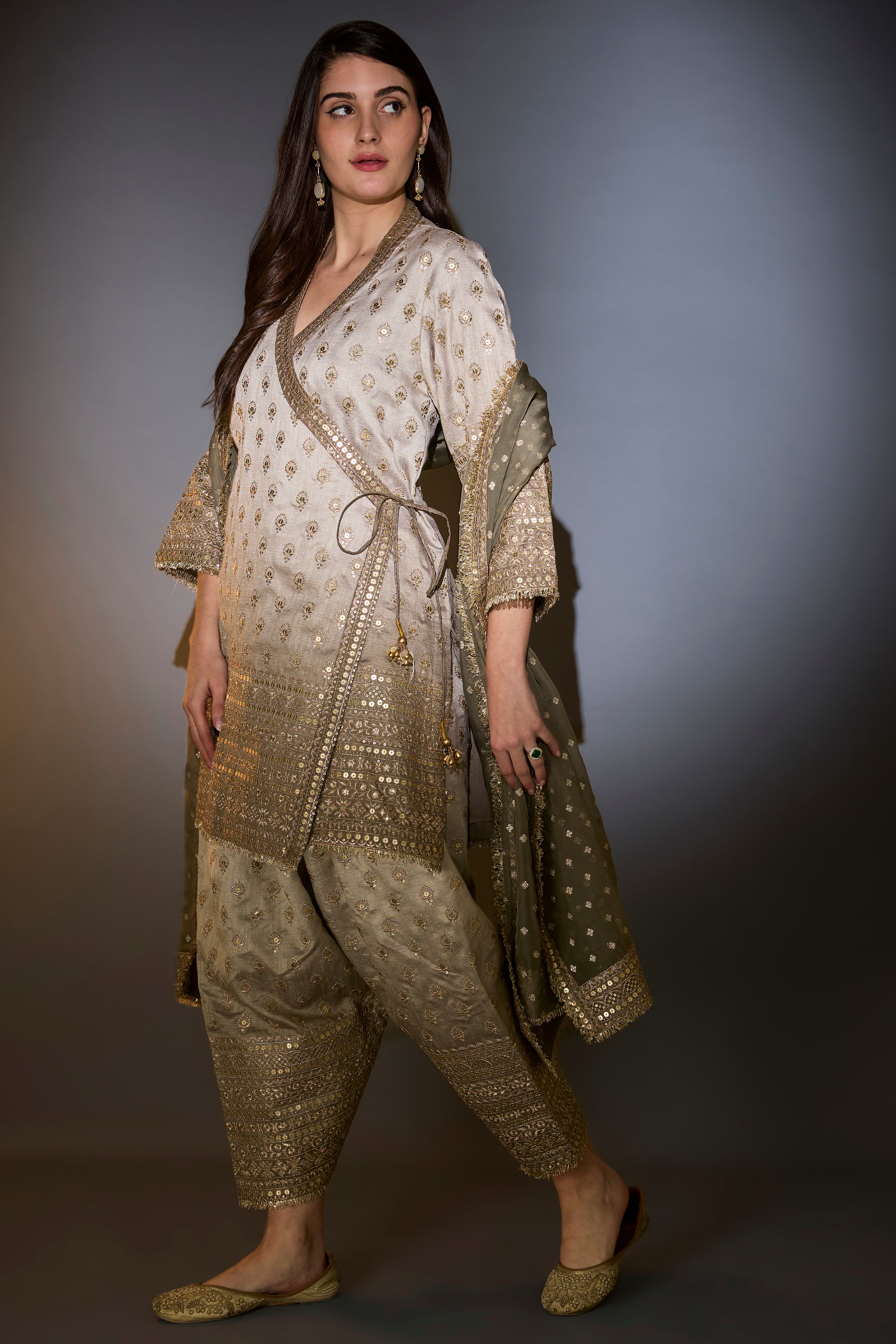 Sage green ombre shades silk suit set in angrakha style with heavy zari and sequin work.