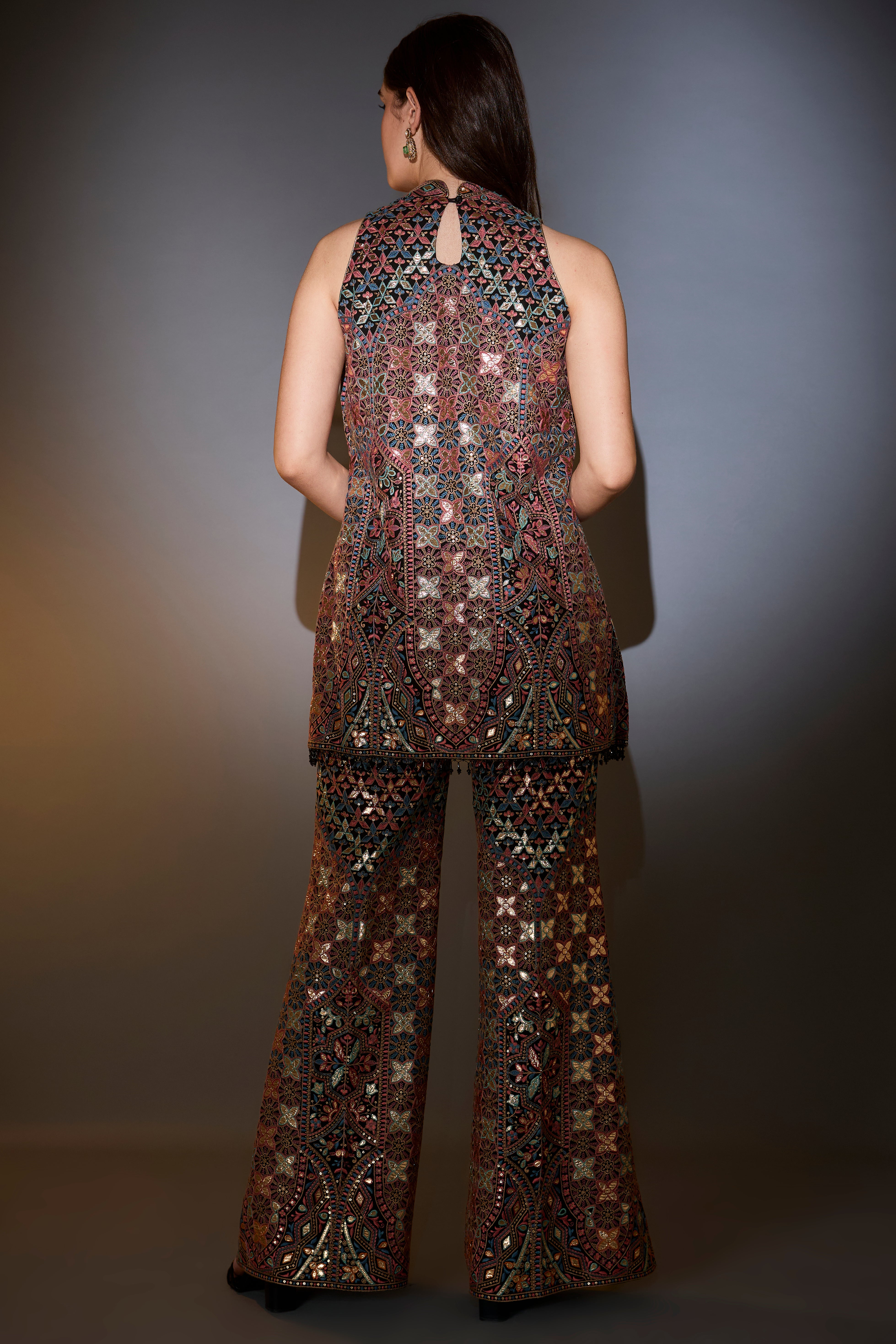 Mutli-coloured leather patch work co-ord set paired with boot-cut trousers.