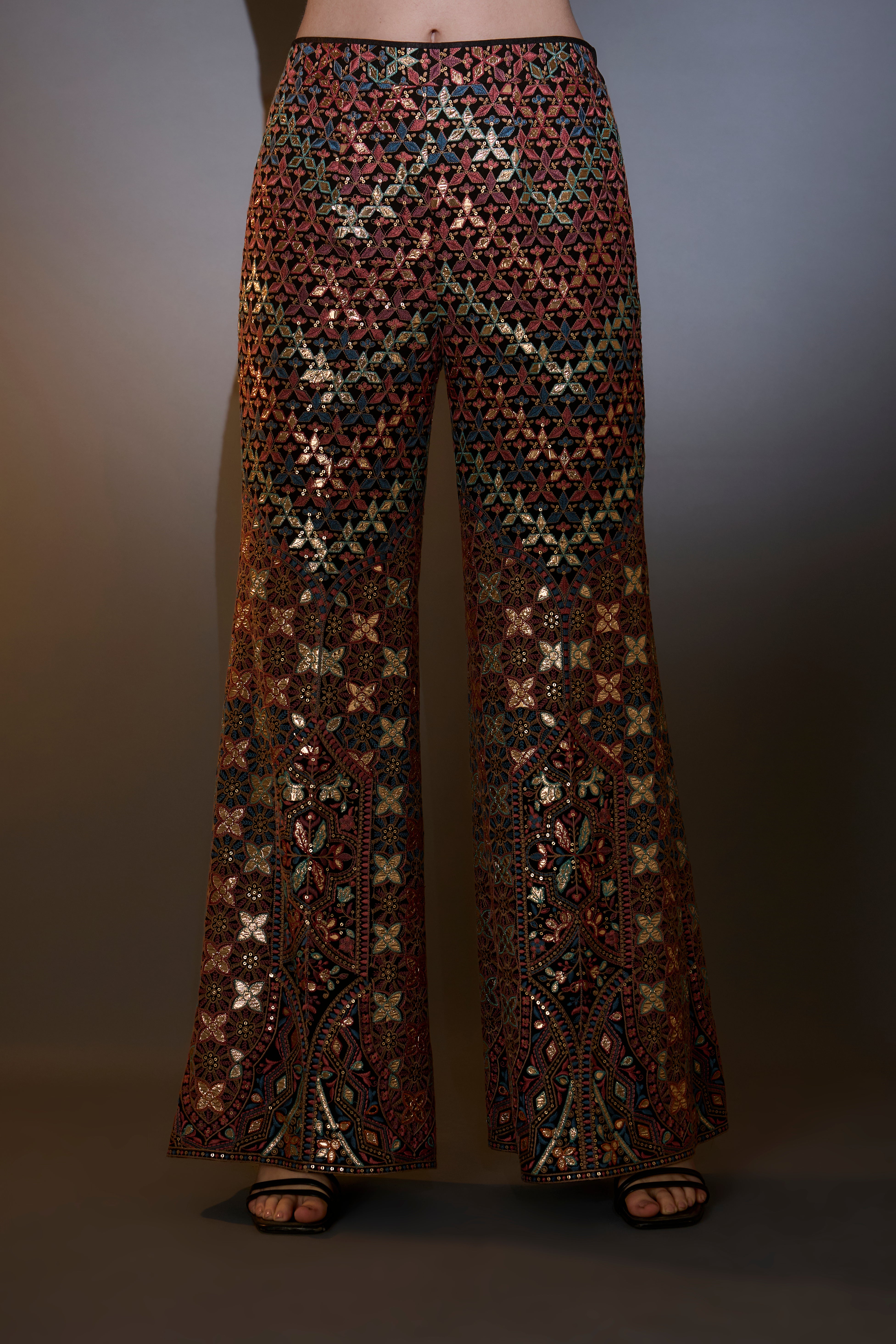 Mutli-coloured leather patch work co-ord set paired with boot-cut trousers.