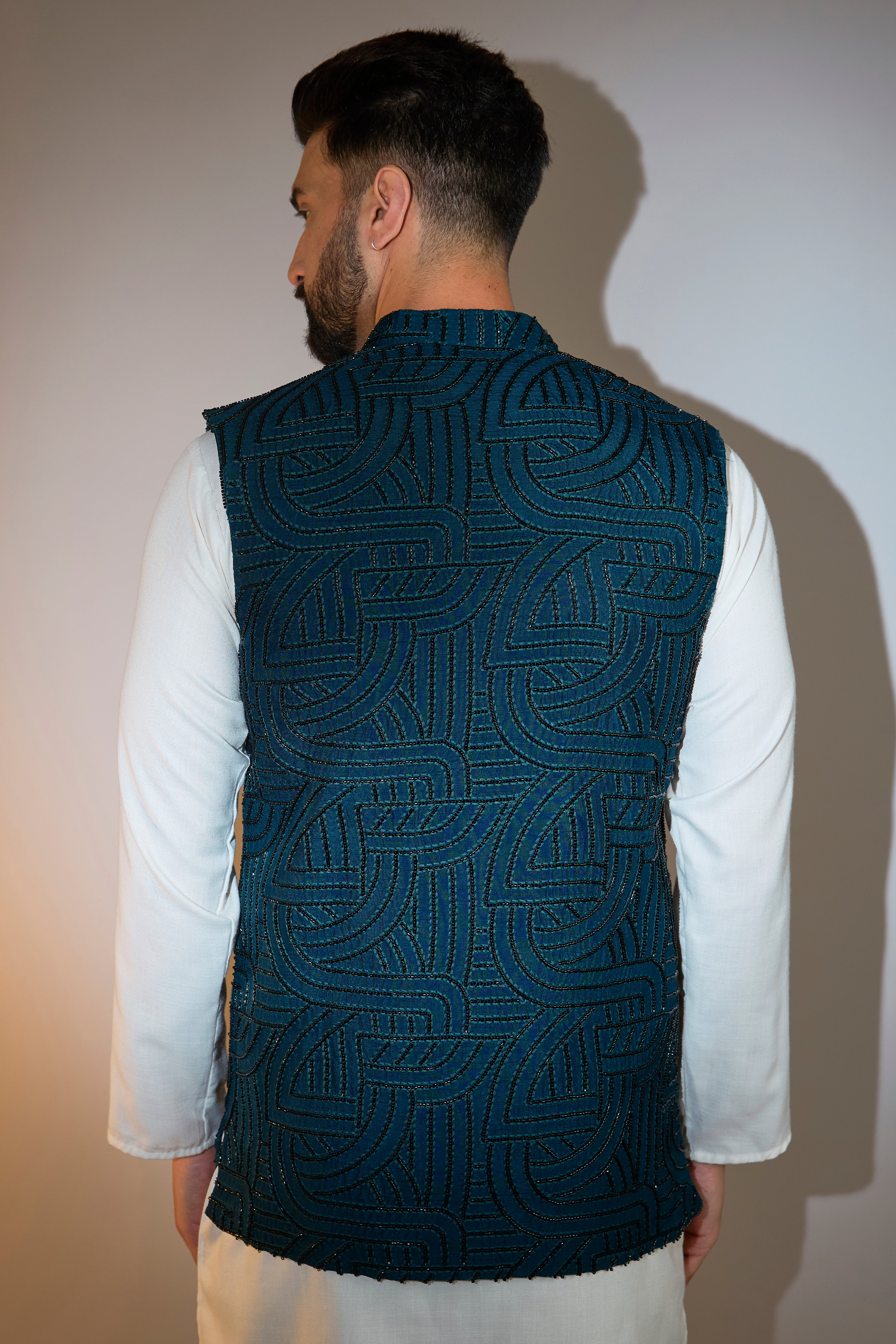 teal short jacket with intricate cut dana embroidery