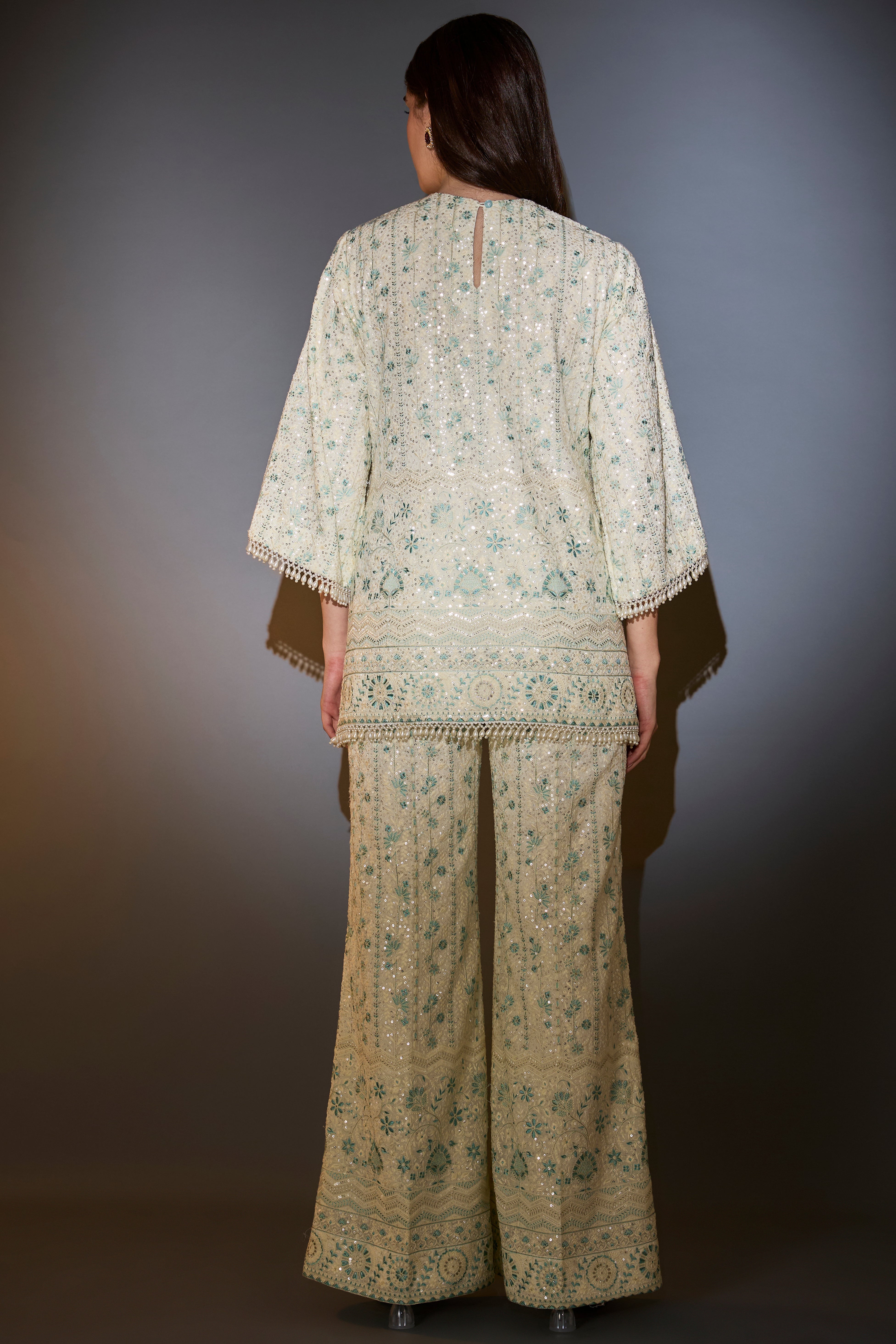 White and aqua chikankari co-ord set with intricate thread and sequin embroidery.