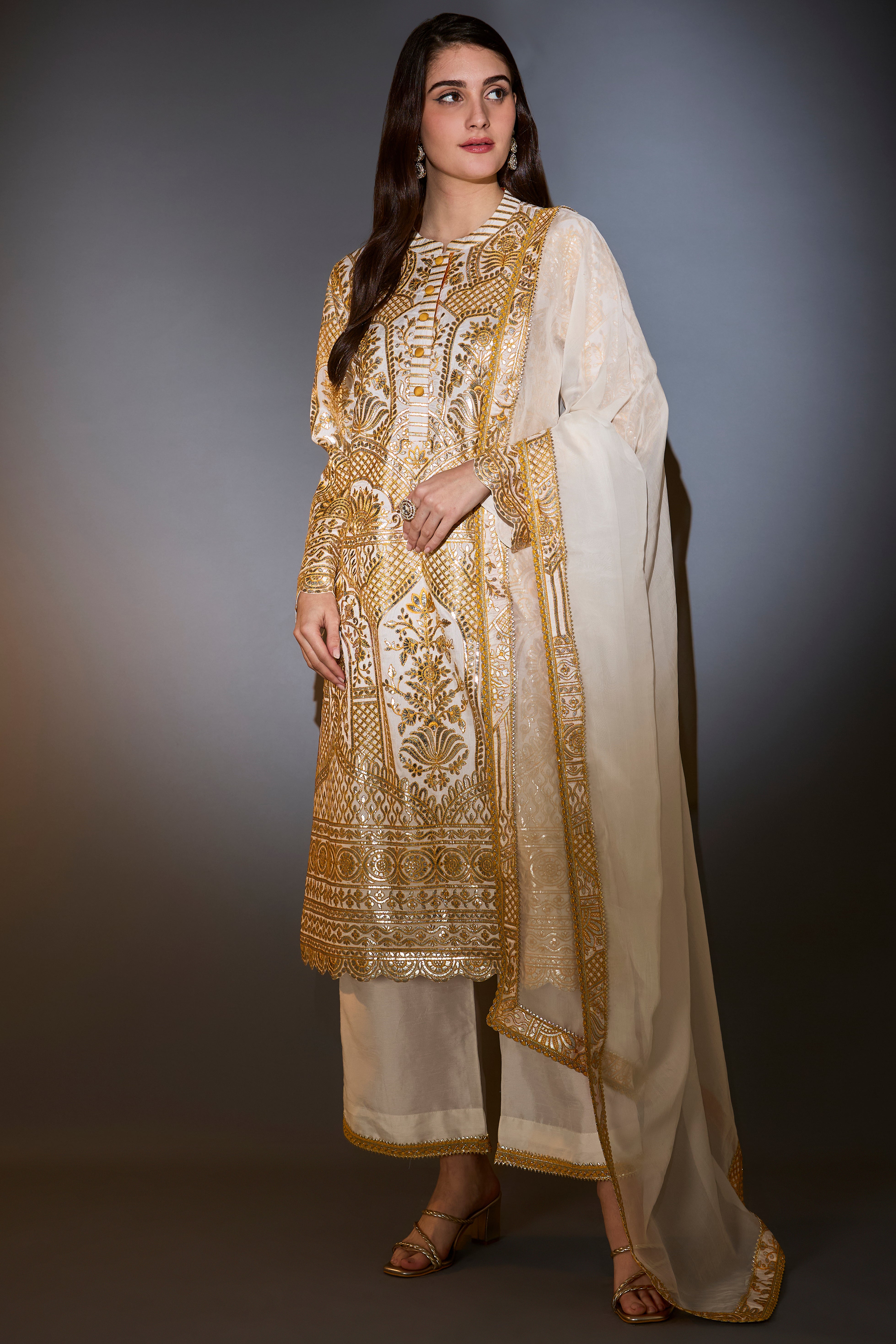 Yellow and ivory suit set with heavy gota embroidery paired with dupatta with border.